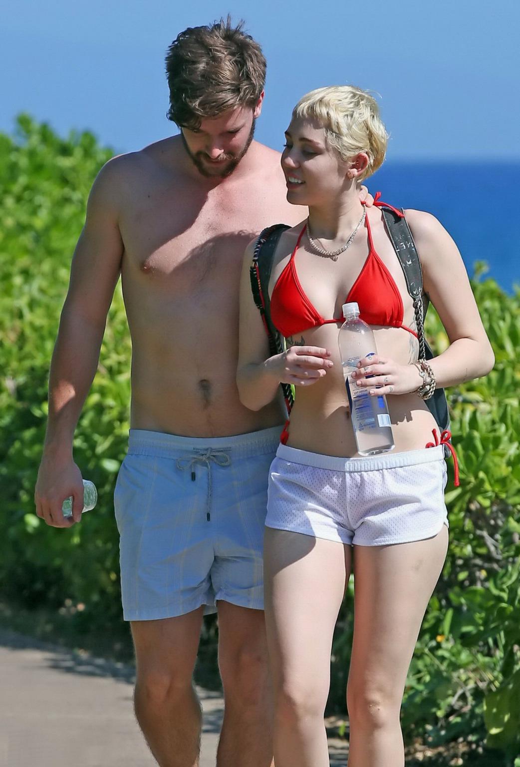 16P Miley Cyrus wearing tiny red bikini and seethrough shorts at a vacation in Hawai