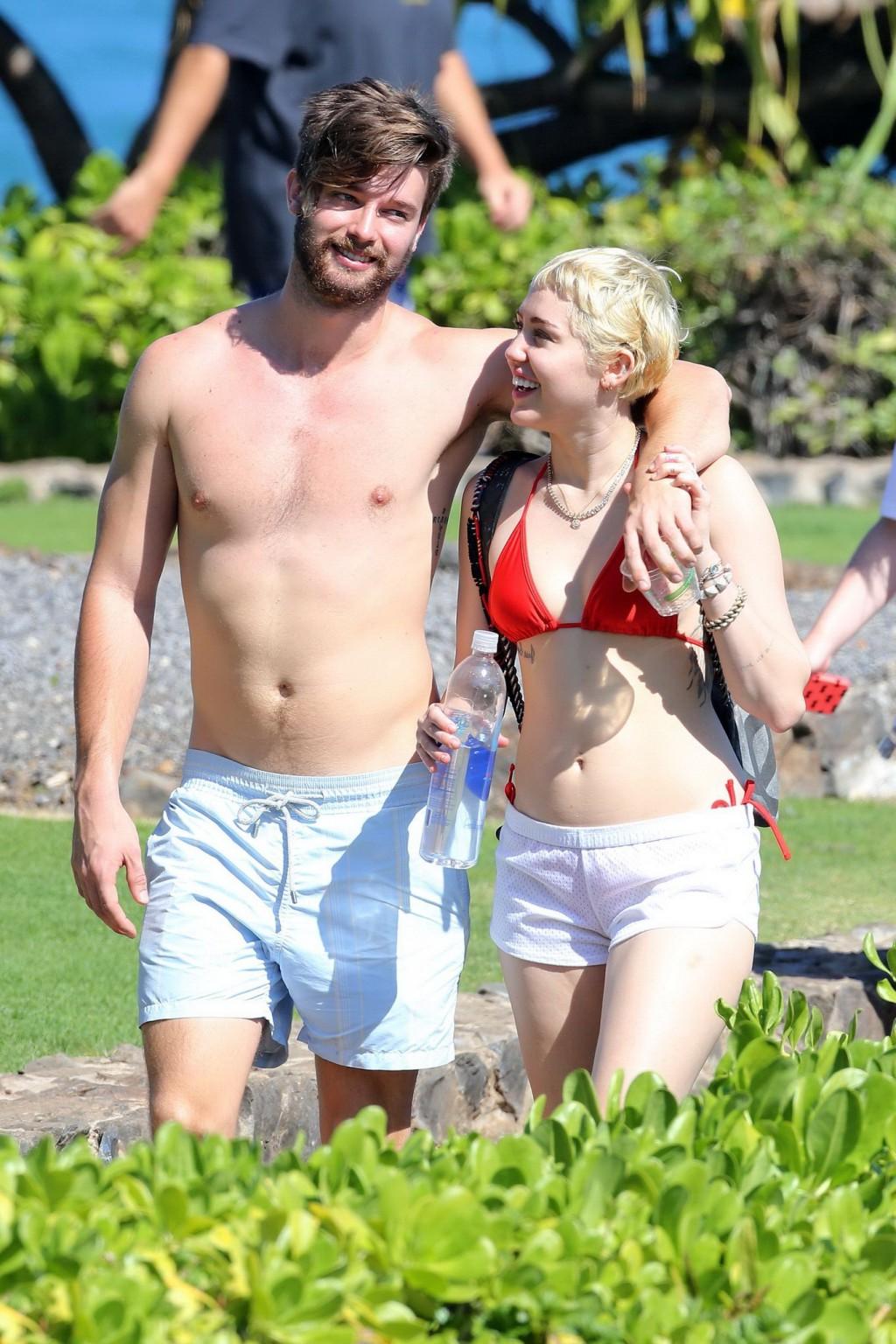 16P Miley Cyrus wearing tiny red bikini and seethrough shorts at a vacation in Hawai