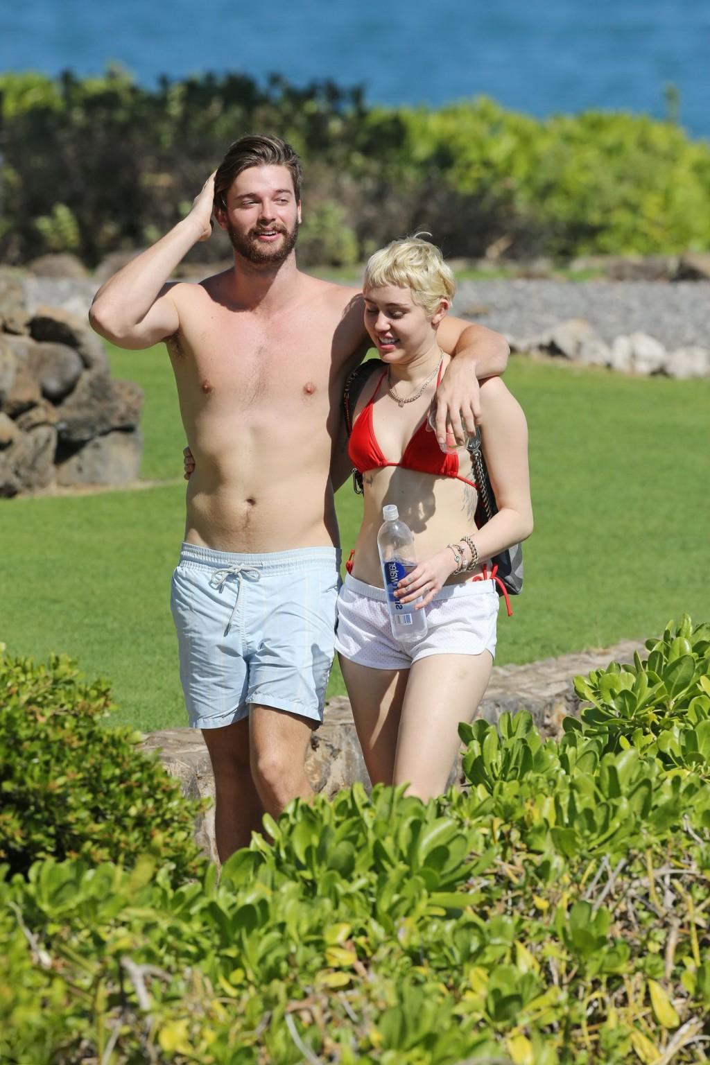 16P Miley Cyrus wearing tiny red bikini and seethrough shorts at a vacation in Hawai