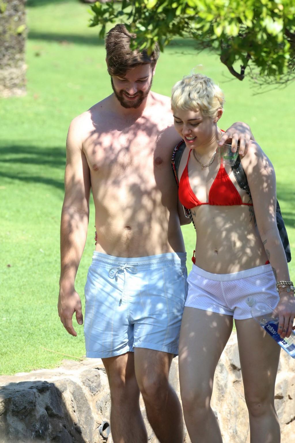 16P Miley Cyrus wearing tiny red bikini and seethrough shorts at a vacation in Hawai