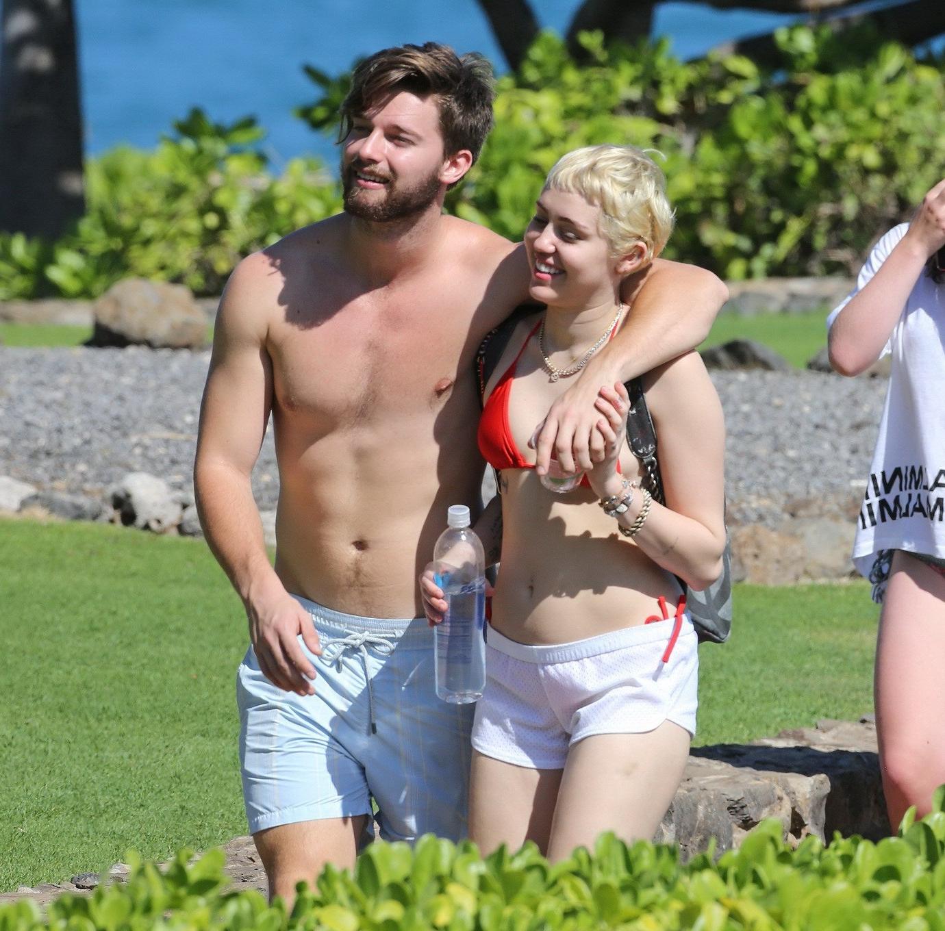 16P Miley Cyrus wearing tiny red bikini and seethrough shorts at a vacation in Hawai
