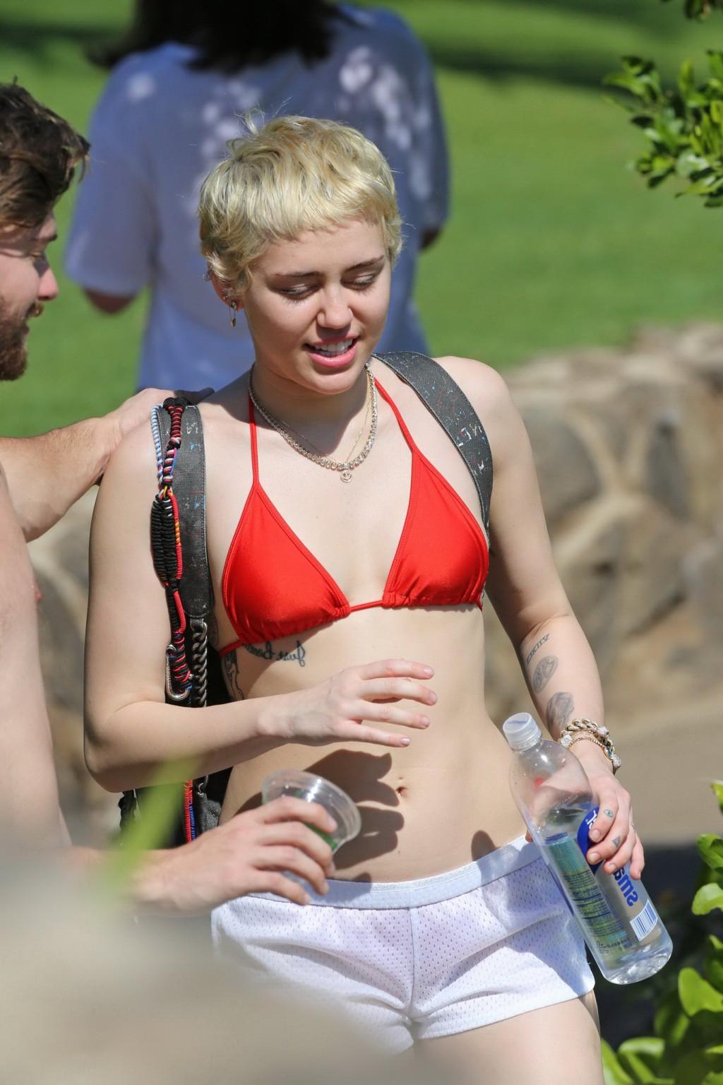 16P Miley Cyrus wearing tiny red bikini and seethrough shorts at a vacation in Hawai