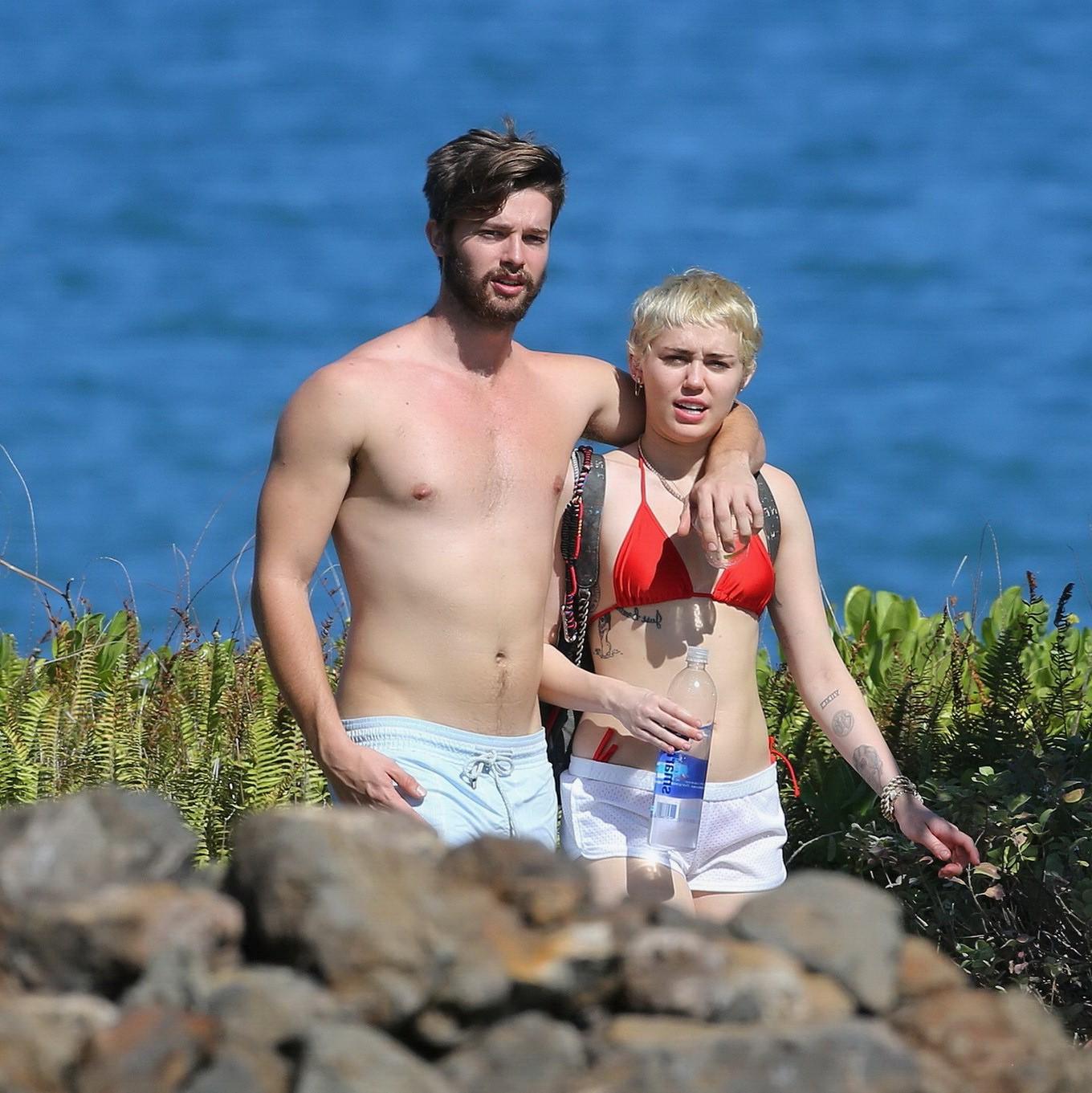 16P Miley Cyrus wearing tiny red bikini and seethrough shorts at a vacation in Hawai
