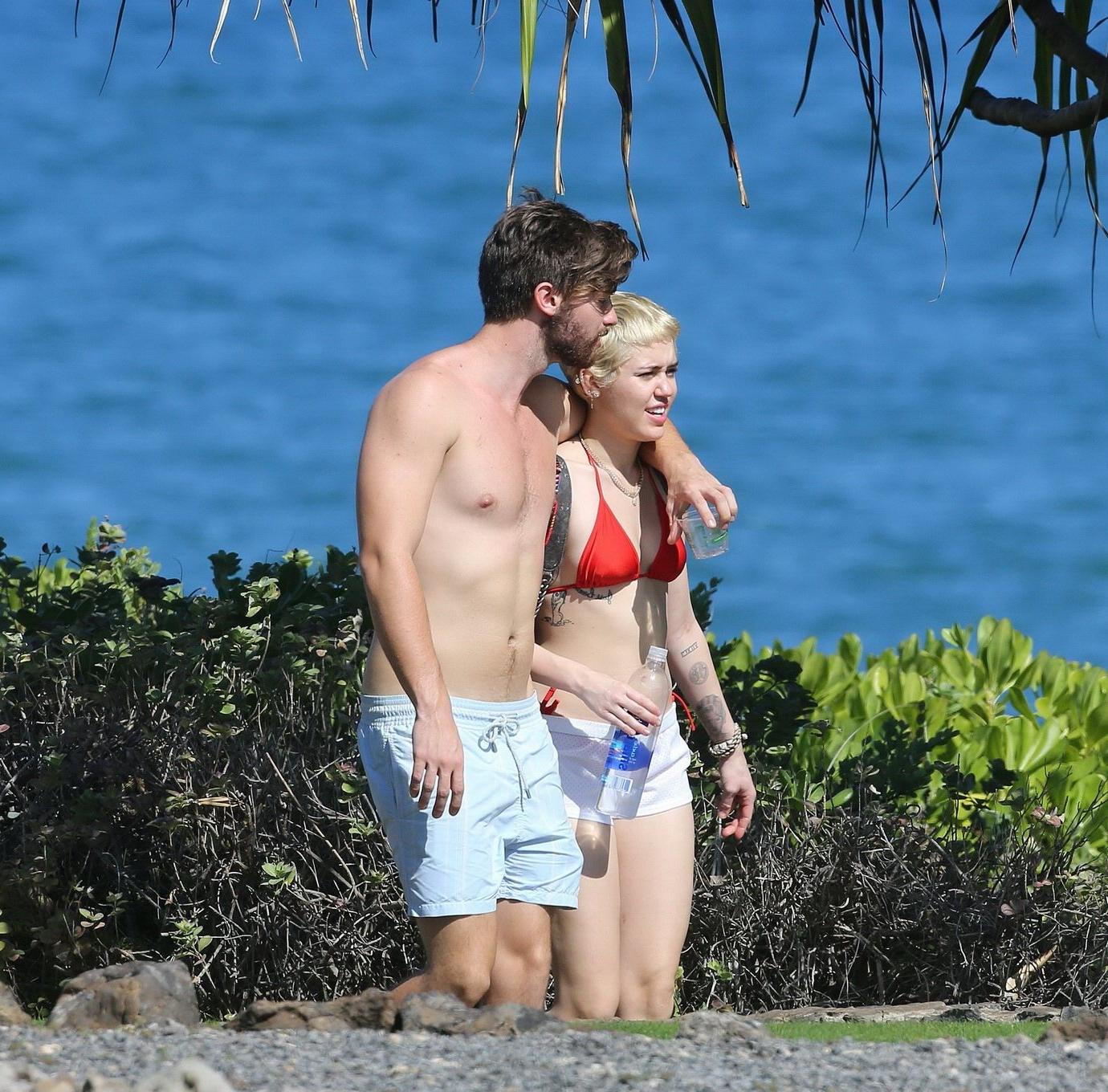 16P Miley Cyrus wearing tiny red bikini and seethrough shorts at a vacation in Hawai