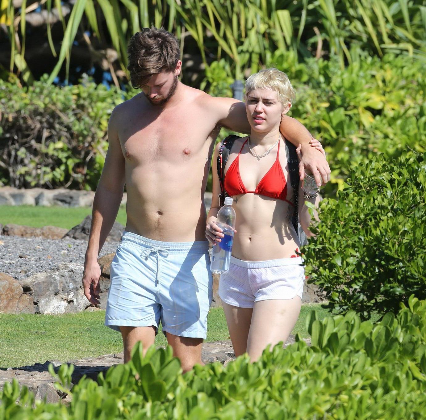 16P Miley Cyrus wearing tiny red bikini and seethrough shorts at a vacation in Hawai