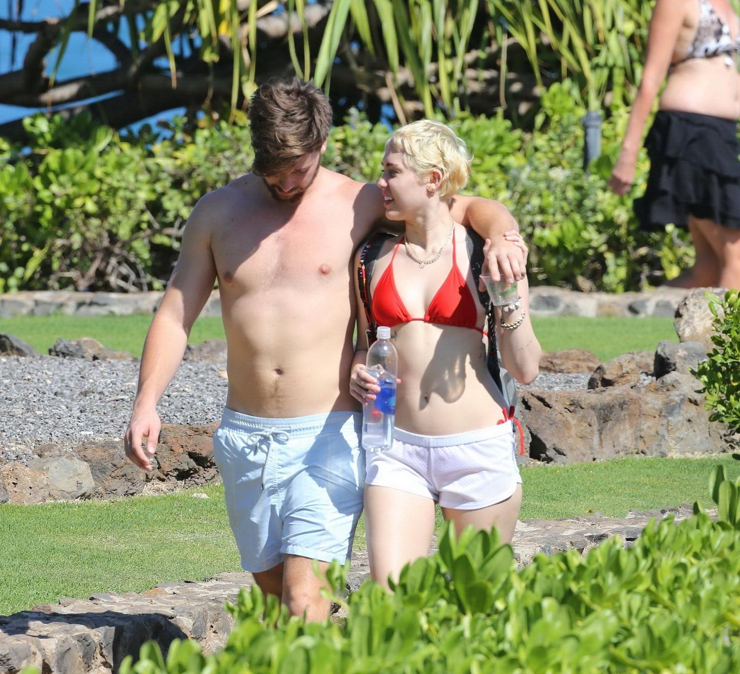 16P Miley Cyrus wearing tiny red bikini and seethrough shorts at a vacation in Hawai