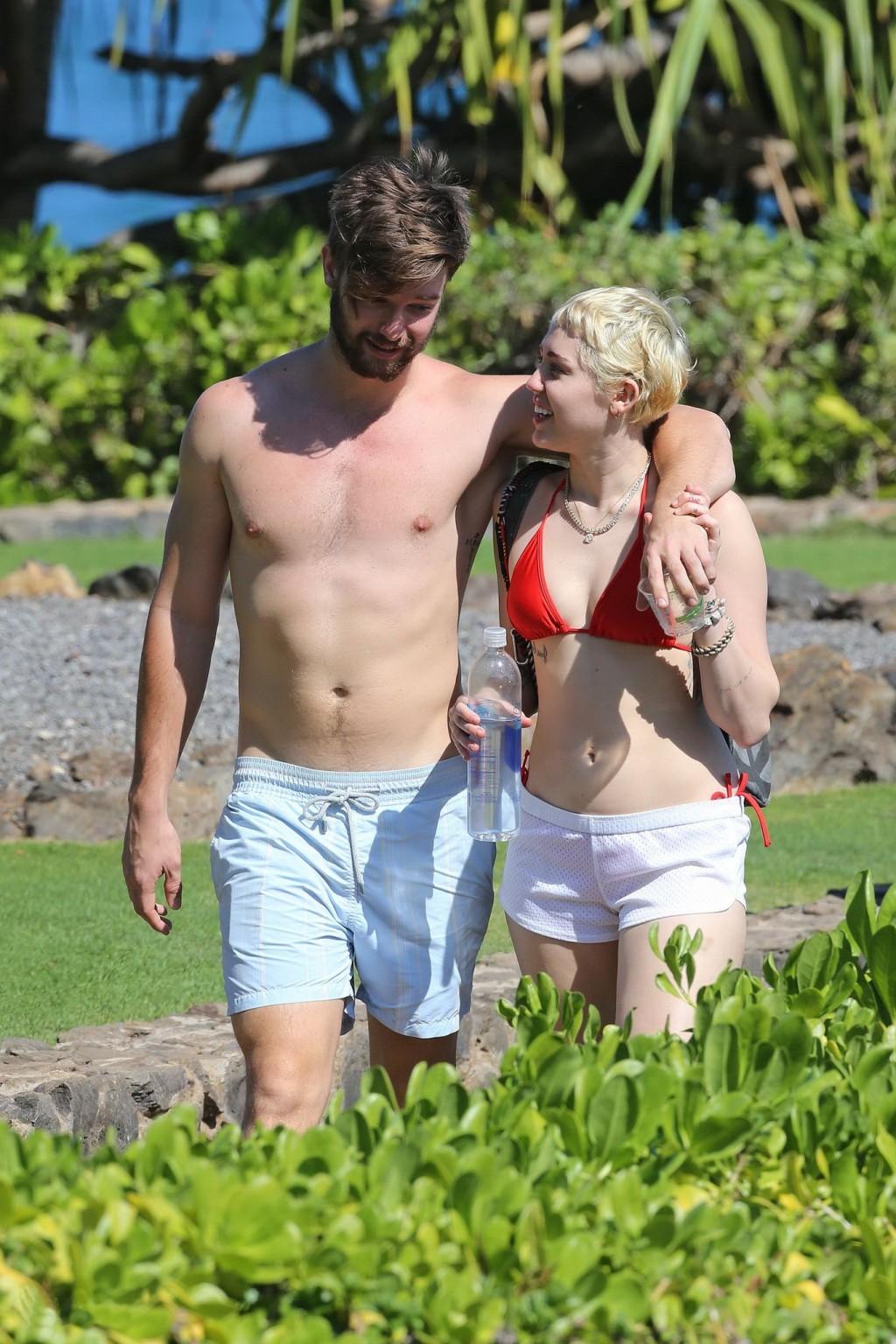 16P Miley Cyrus wearing tiny red bikini and seethrough shorts at a vacation in Hawai