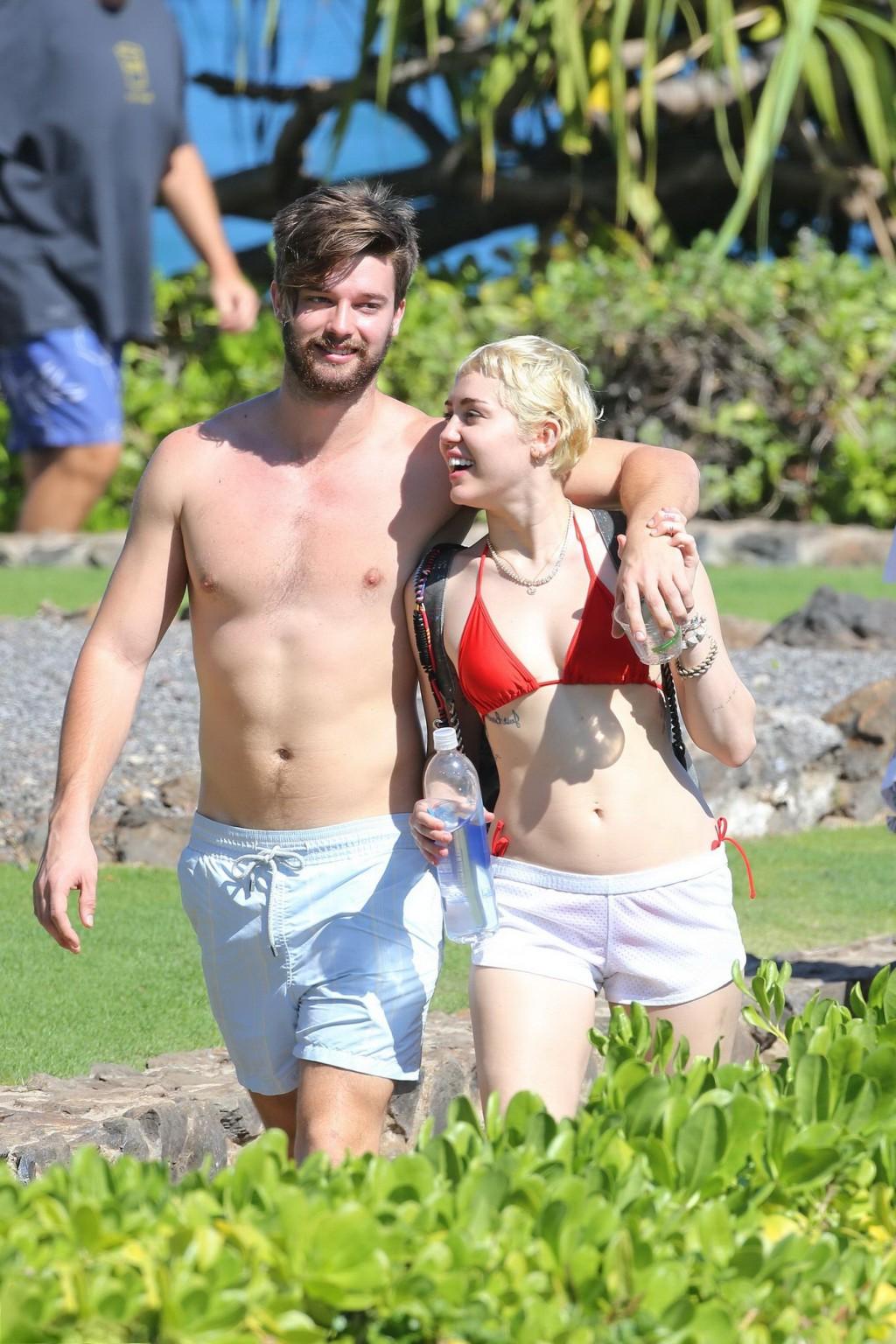 16P Miley Cyrus wearing tiny red bikini and seethrough shorts at a vacation in Hawai