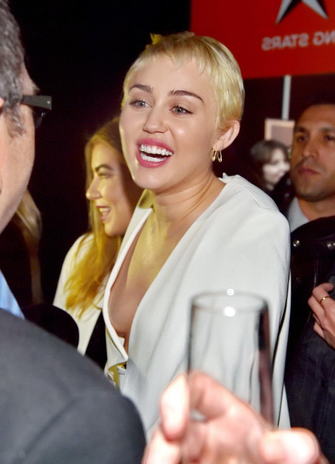 16P Miley Cyrus braless shows cleavage attending the W Magazine Shooting Stars Exhib