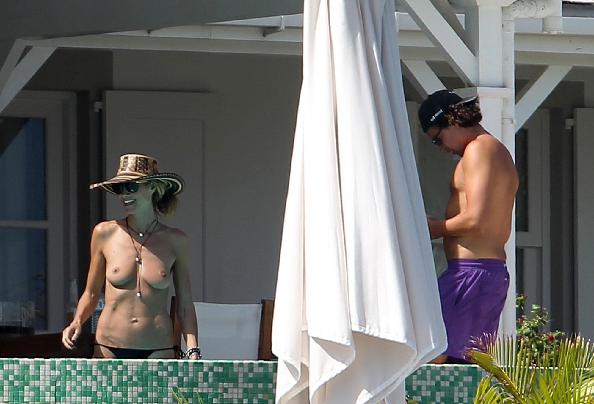 16P Heidi Klum tanning topless poolside in St Barts