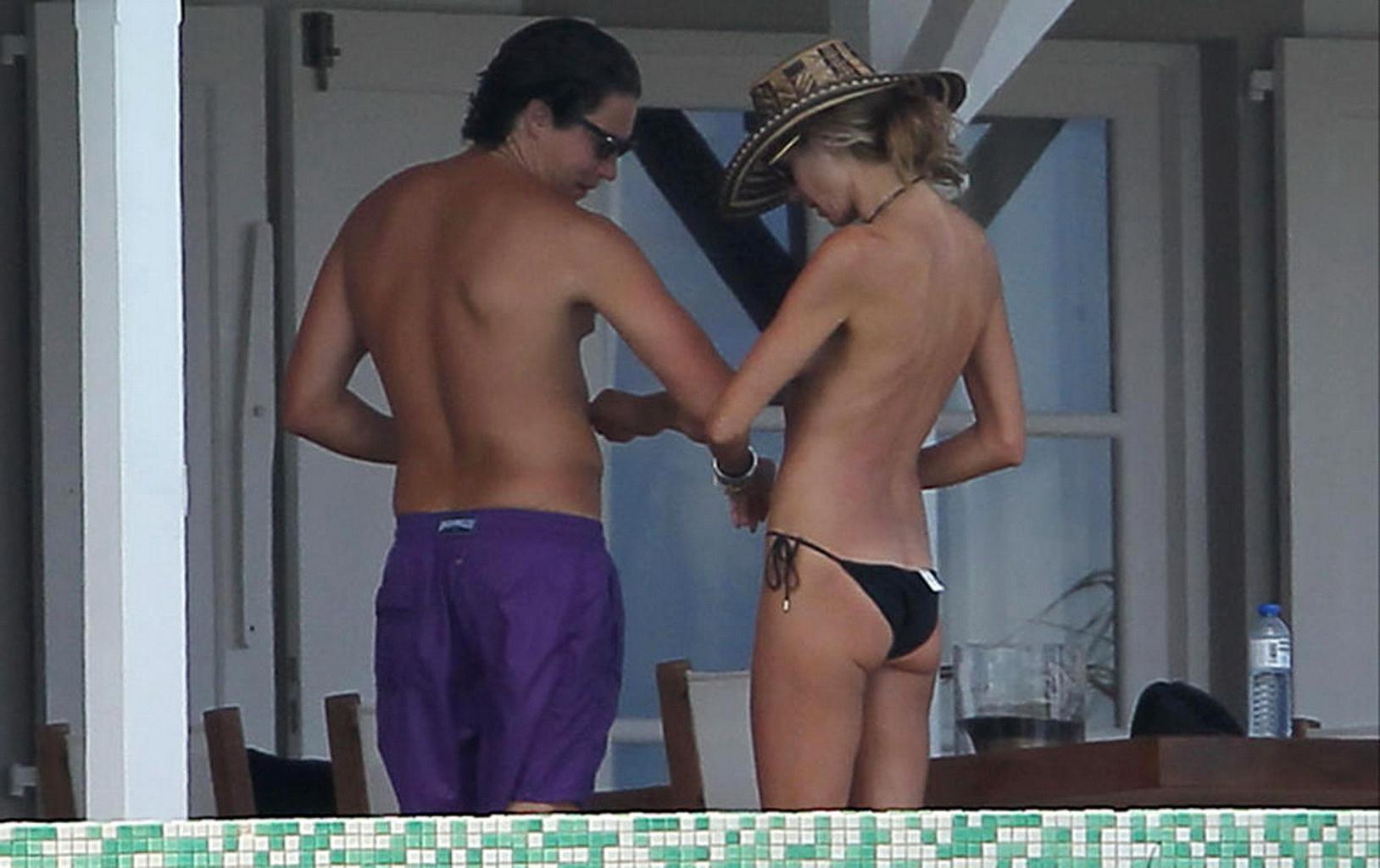 16P Heidi Klum tanning topless poolside in St Barts