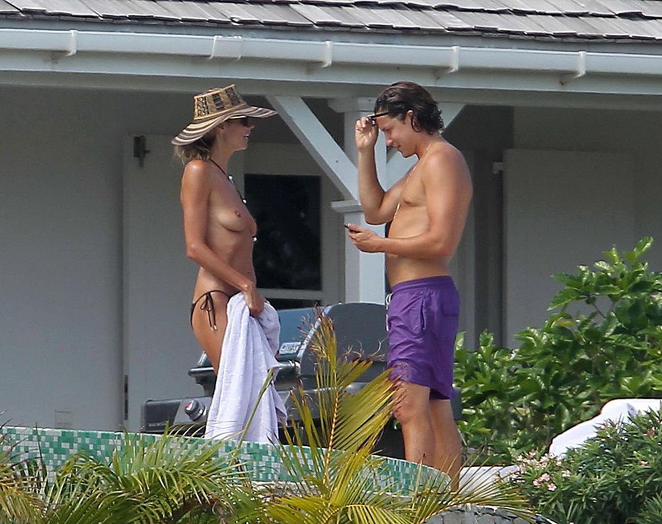 16P Heidi Klum tanning topless poolside in St Barts