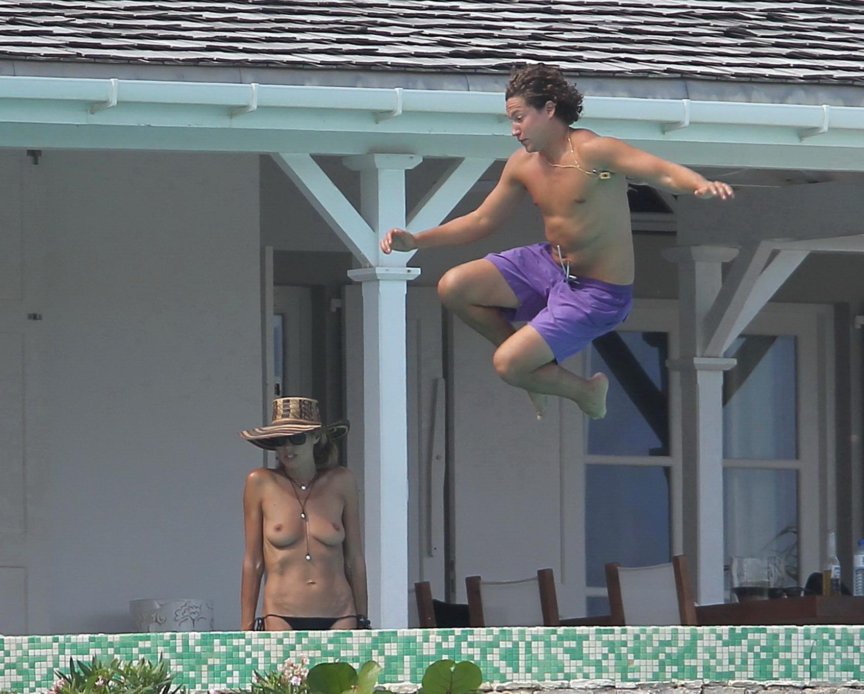 16P Heidi Klum tanning topless poolside in St Barts