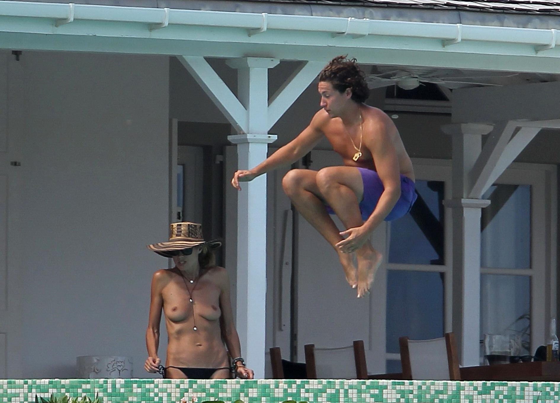 16P Heidi Klum tanning topless poolside in St Barts