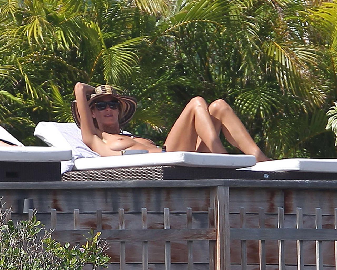16P Heidi Klum tanning topless poolside in St Barts