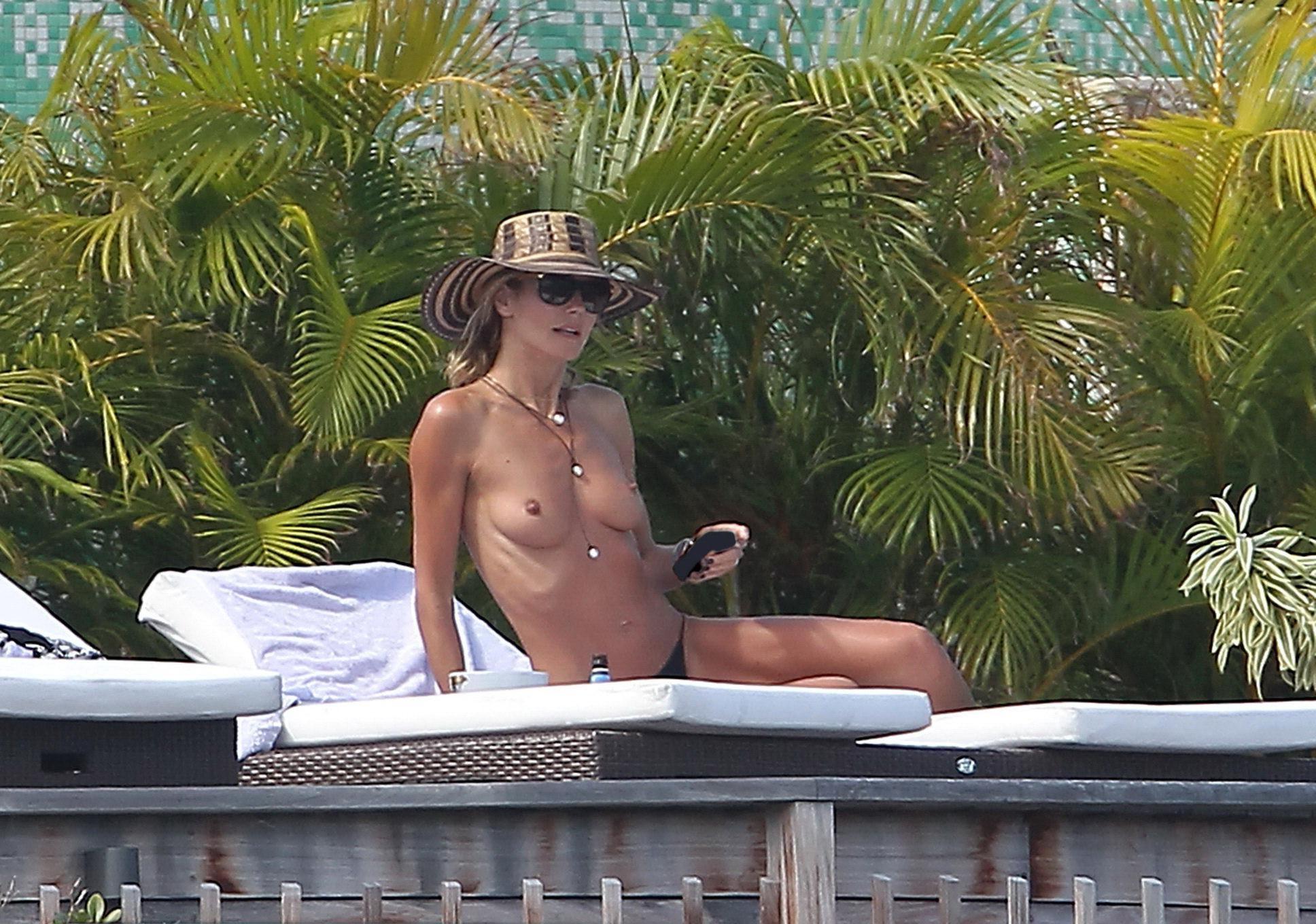 16P Heidi Klum tanning topless poolside in St Barts