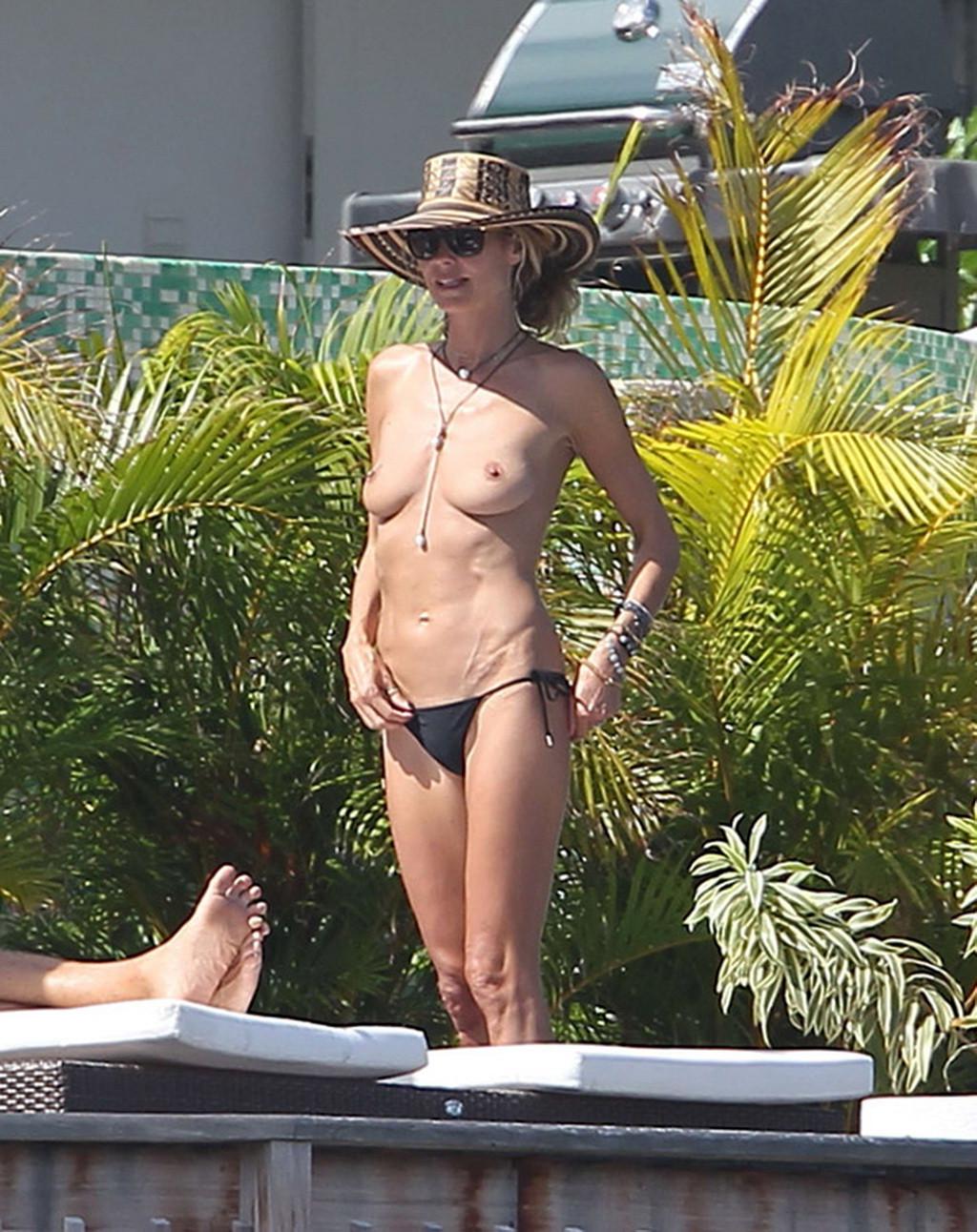 16P Heidi Klum tanning topless poolside in St Barts