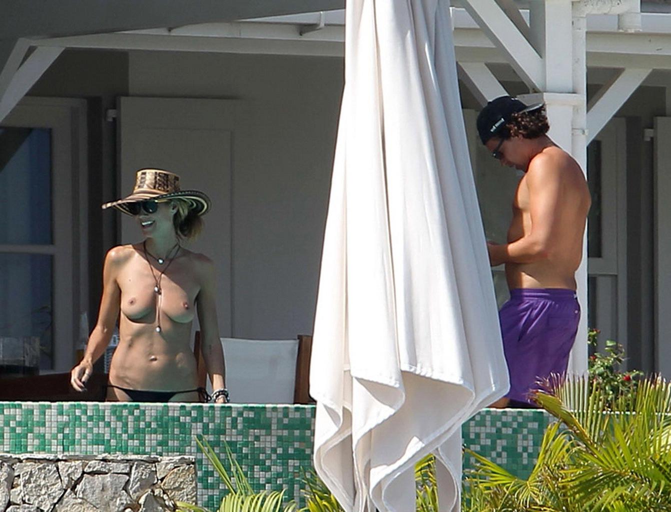 16P Heidi Klum tanning topless poolside in St Barts