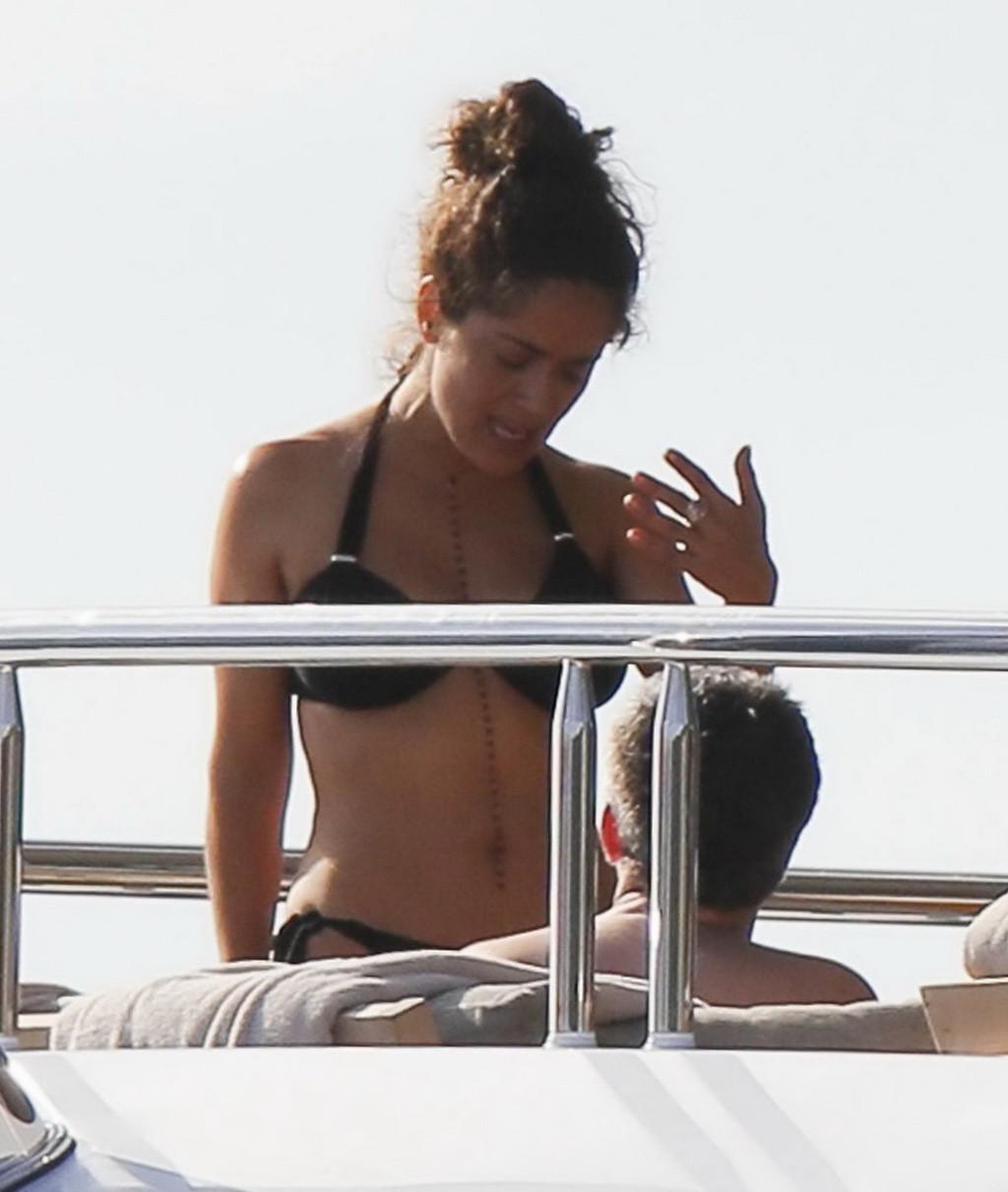 16P Salma Hayek shows off her big boobs and ass in tiny black bikini at a yacht in S
