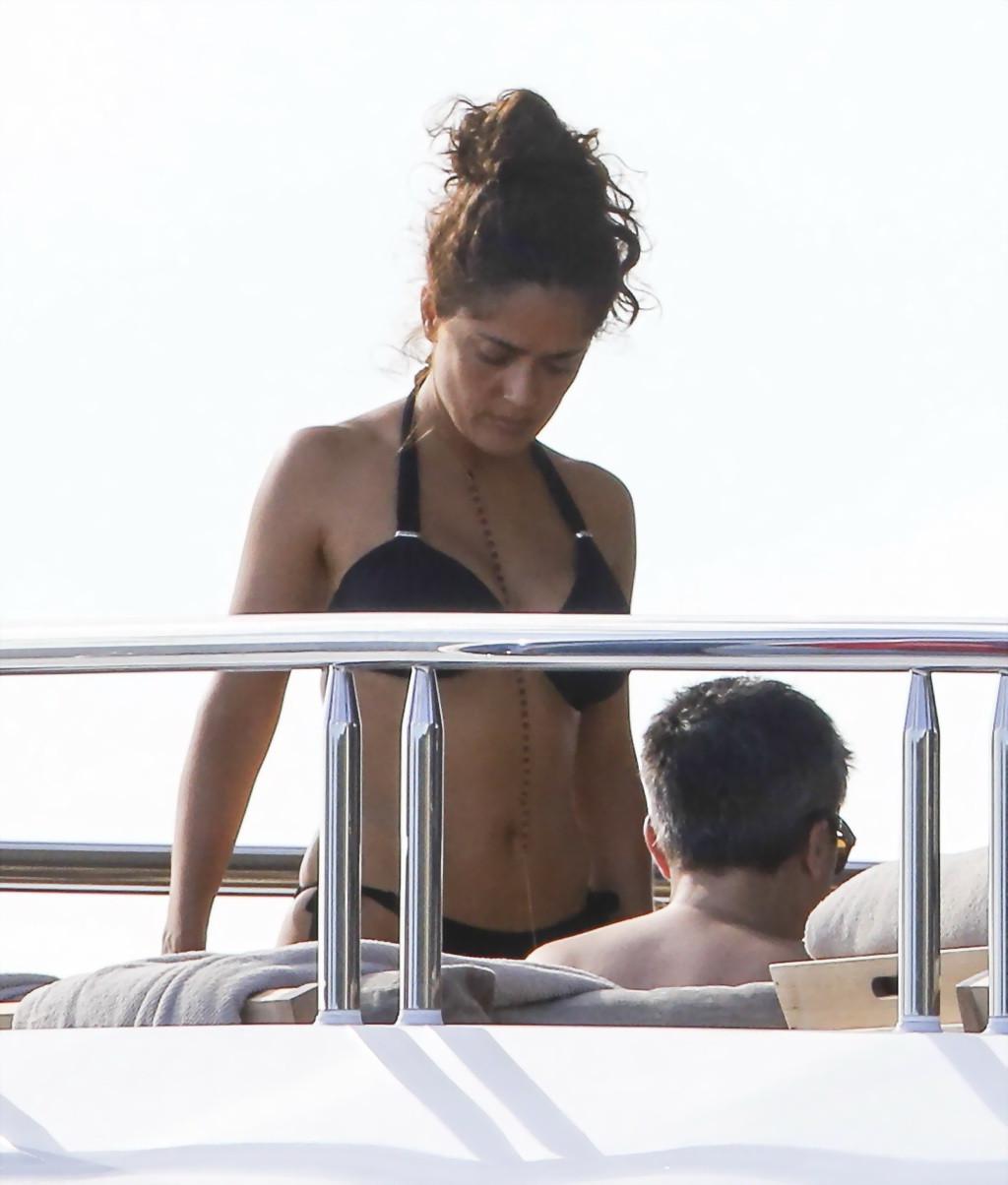 16P Salma Hayek shows off her big boobs and ass in tiny black bikini at a yacht in S