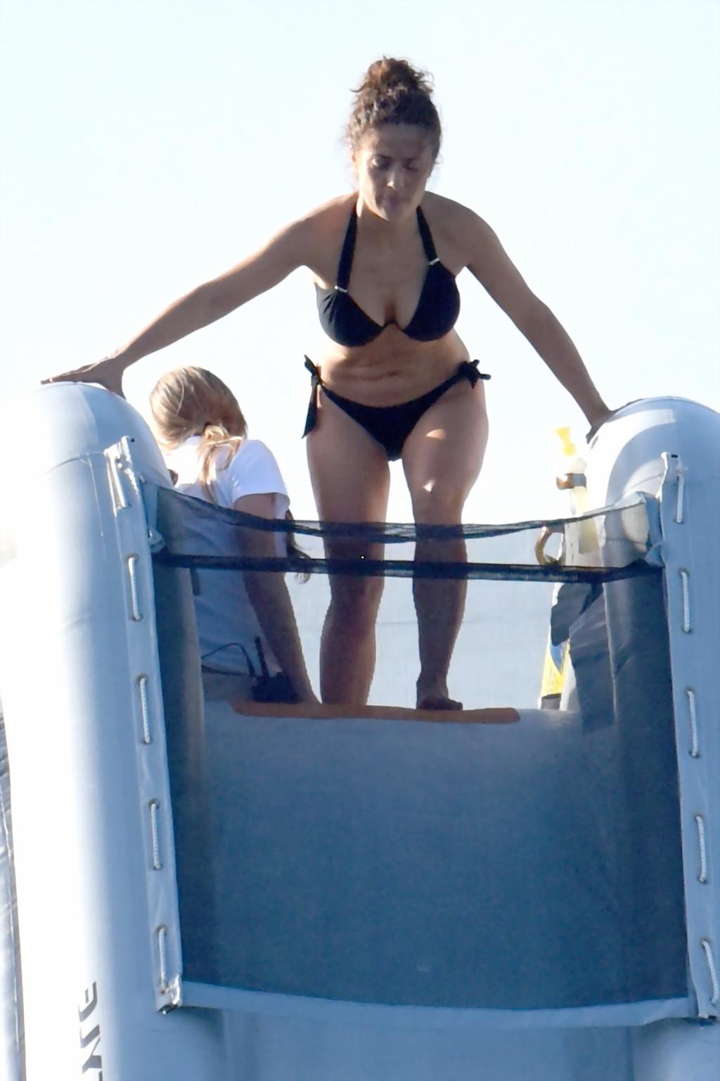 16P Salma Hayek shows off her big boobs and ass in tiny black bikini at a yacht in S