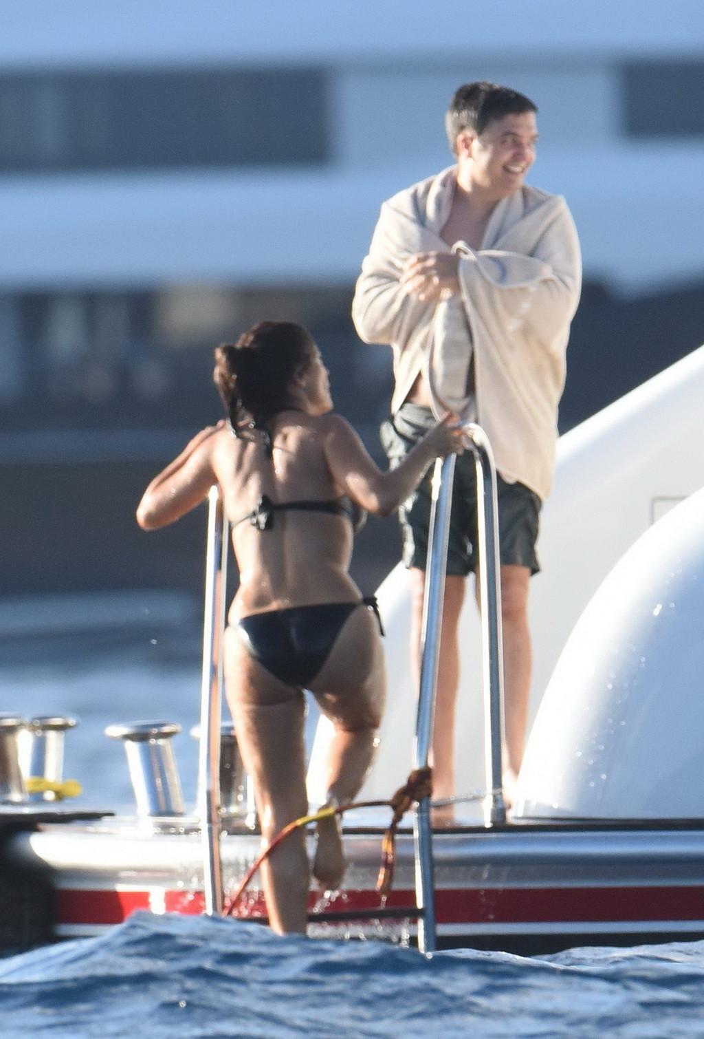 16P Salma Hayek shows off her big boobs and ass in tiny black bikini at a yacht in S