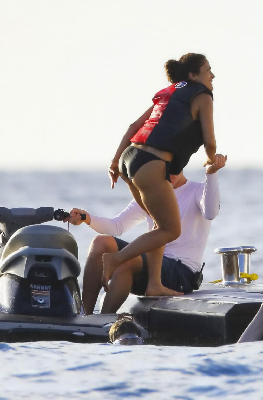 16P Salma Hayek shows off her big boobs and ass in tiny black bikini at a yacht in S