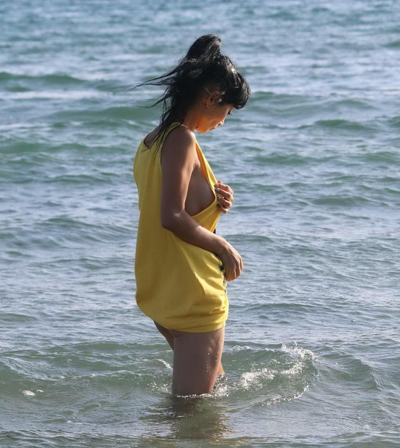 16P Bai Ling shows sideboob and pokies in wet tshirt and bikini bottom at the beach 