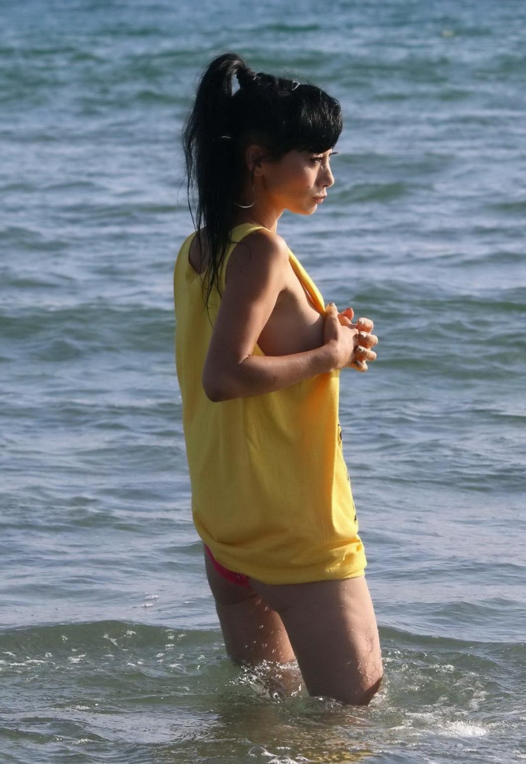 16P Bai Ling shows sideboob and pokies in wet tshirt and bikini bottom at the beach 