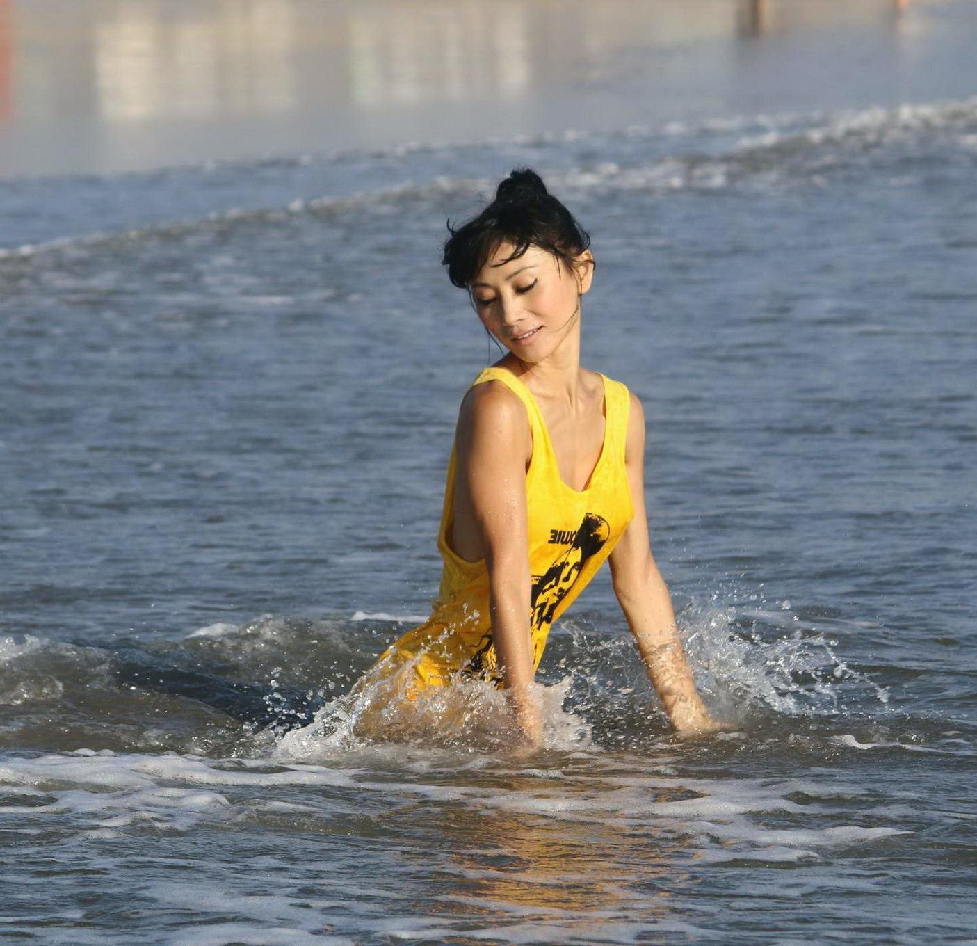 16P Bai Ling shows sideboob and pokies in wet tshirt and bikini bottom at the beach 