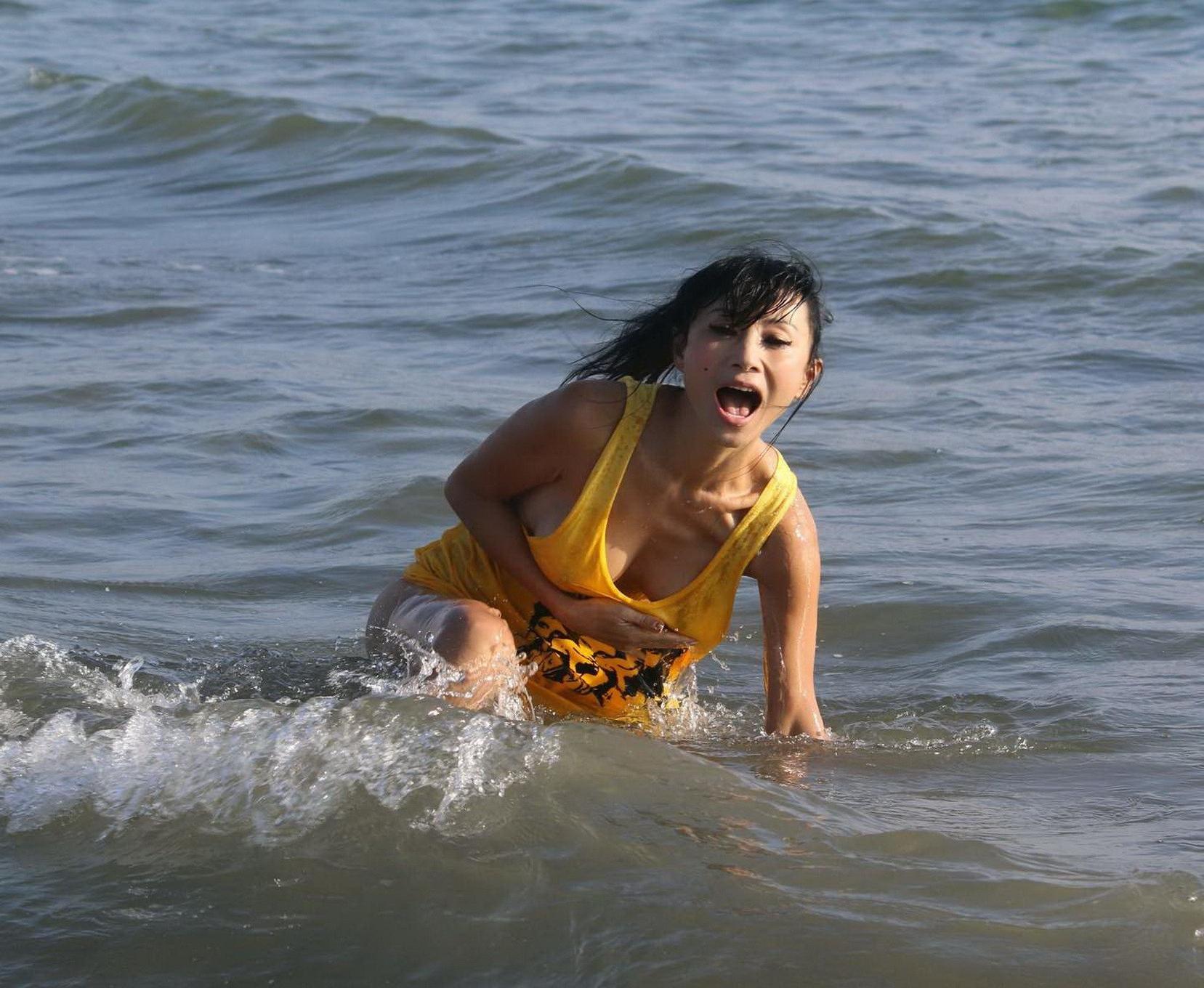 16P Bai Ling shows sideboob and pokies in wet tshirt and bikini bottom at the beach 