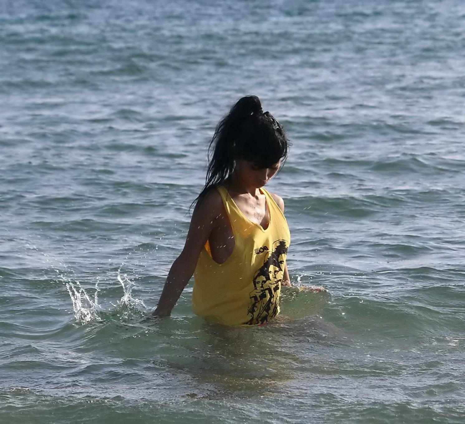 16P Bai Ling shows sideboob and pokies in wet tshirt and bikini bottom at the beach 