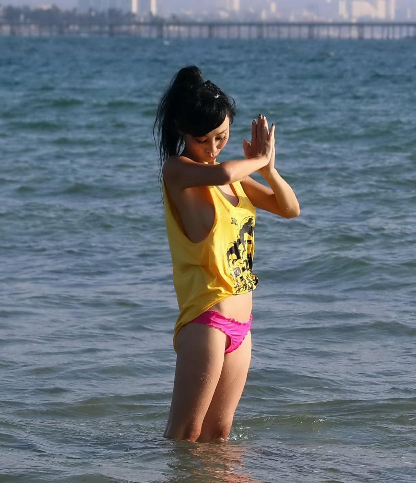 16P Bai Ling shows sideboob and pokies in wet tshirt and bikini bottom at the beach 