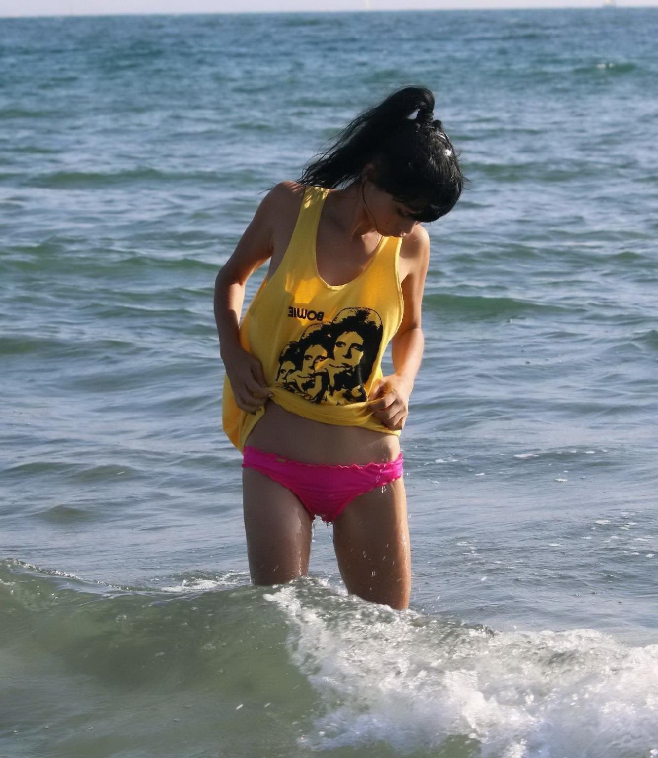 16P Bai Ling shows sideboob and pokies in wet tshirt and bikini bottom at the beach 