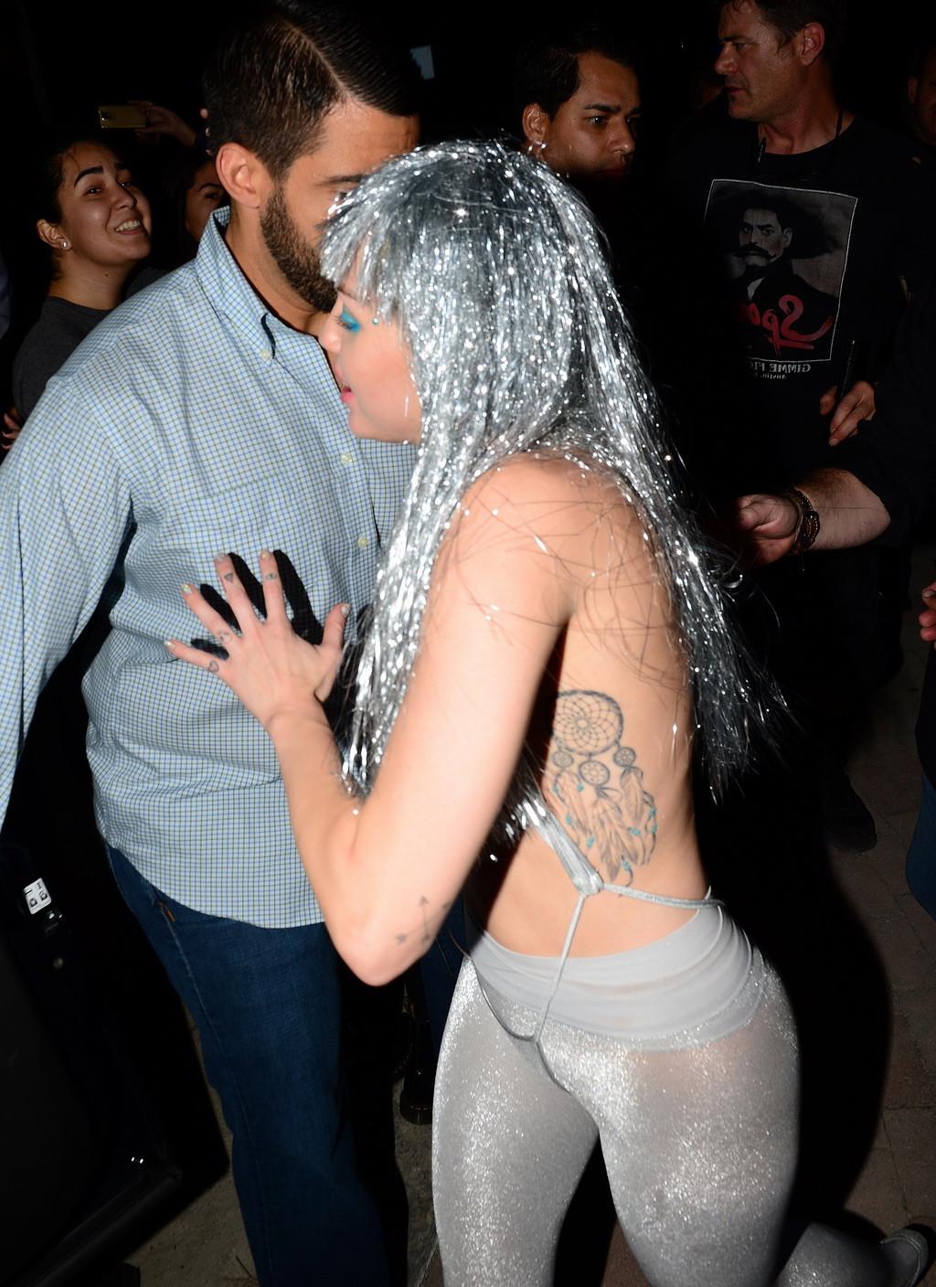 16P Miley Cyrus topless but wearing pasties and pantyhose at Art Basel in Miami