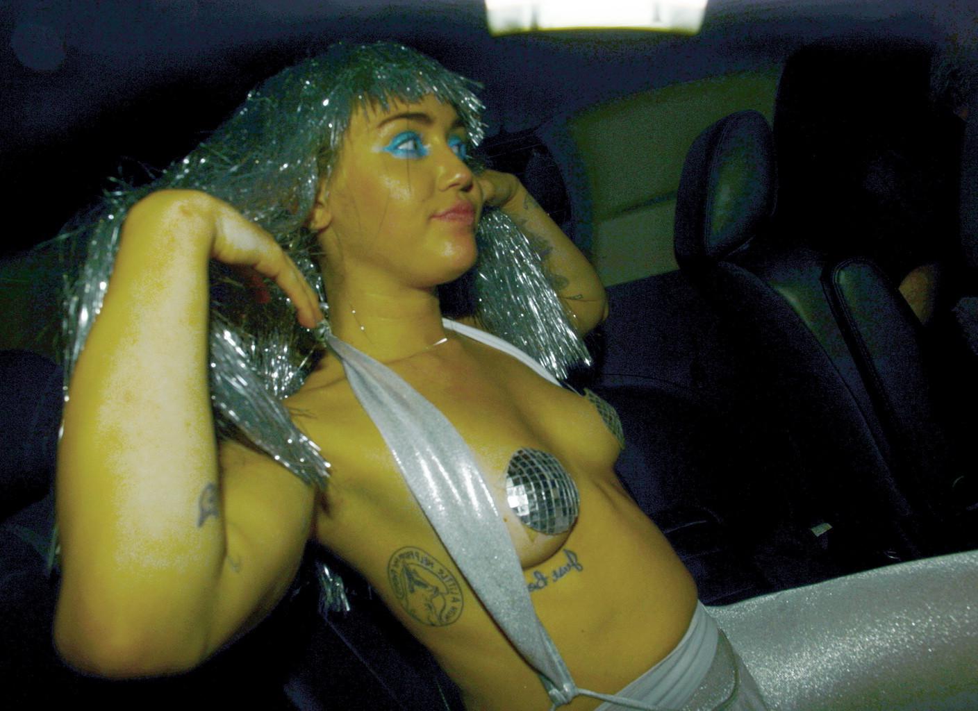 16P Miley Cyrus topless but wearing pasties and pantyhose at Art Basel in Miami