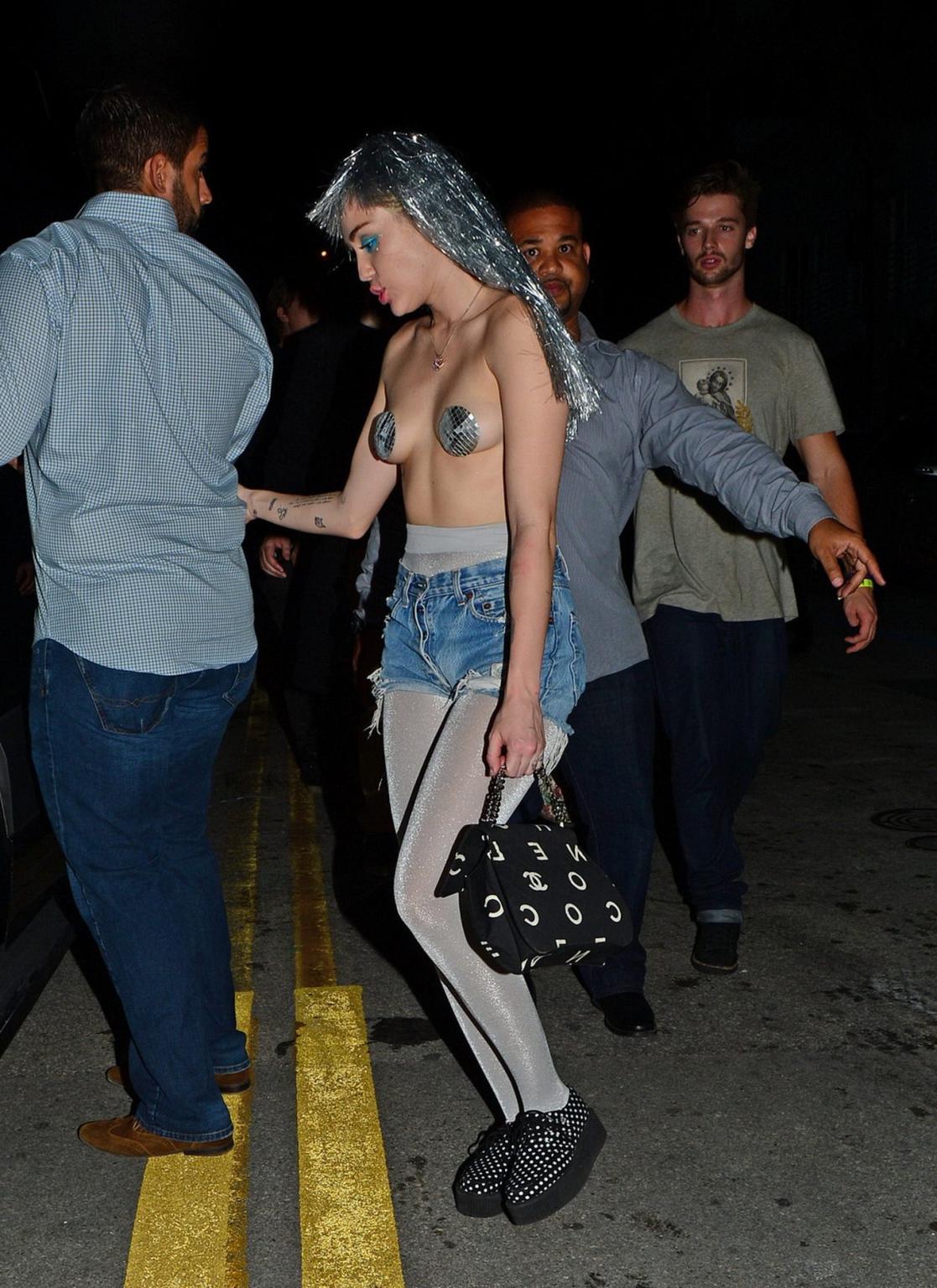 16P Miley Cyrus topless but wearing pasties and pantyhose at Art Basel in Miami