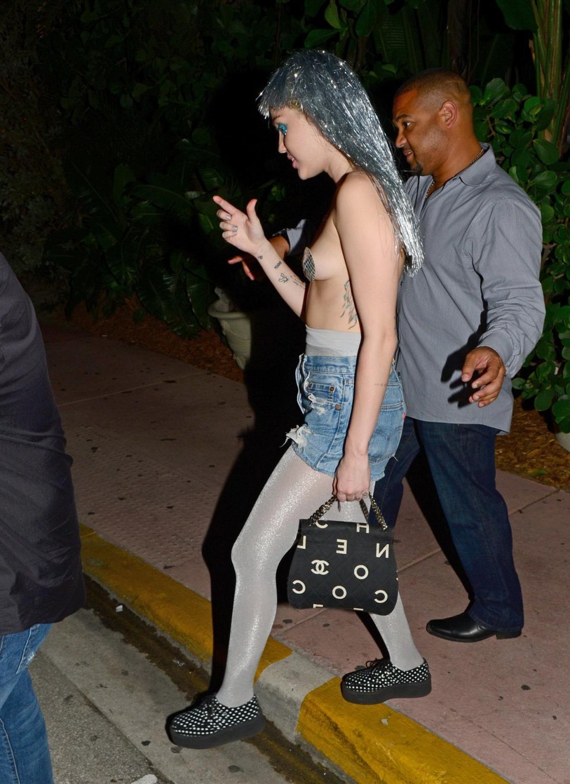 16P Miley Cyrus topless but wearing pasties and pantyhose at Art Basel in Miami