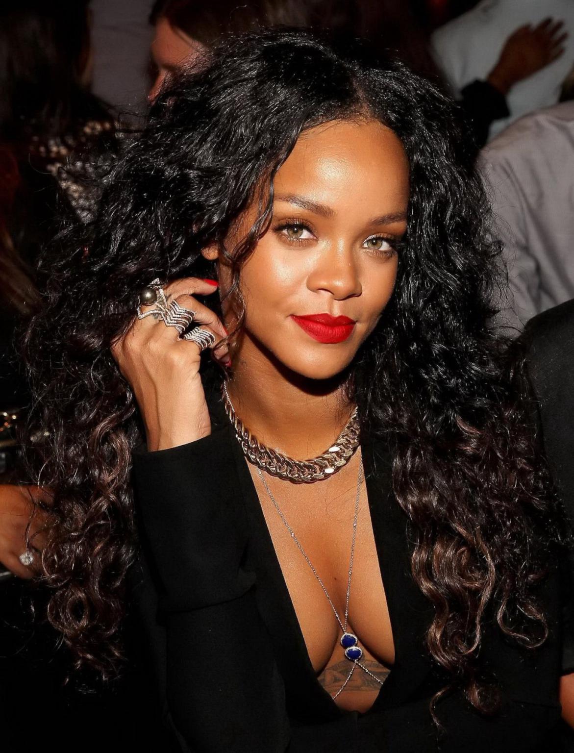 16P Rihanna cleavy and flashing her panties in a wide open black mini dress at the f