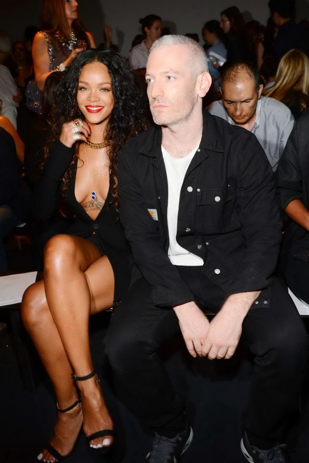 16P Rihanna cleavy and flashing her panties in a wide open black mini dress at the f
