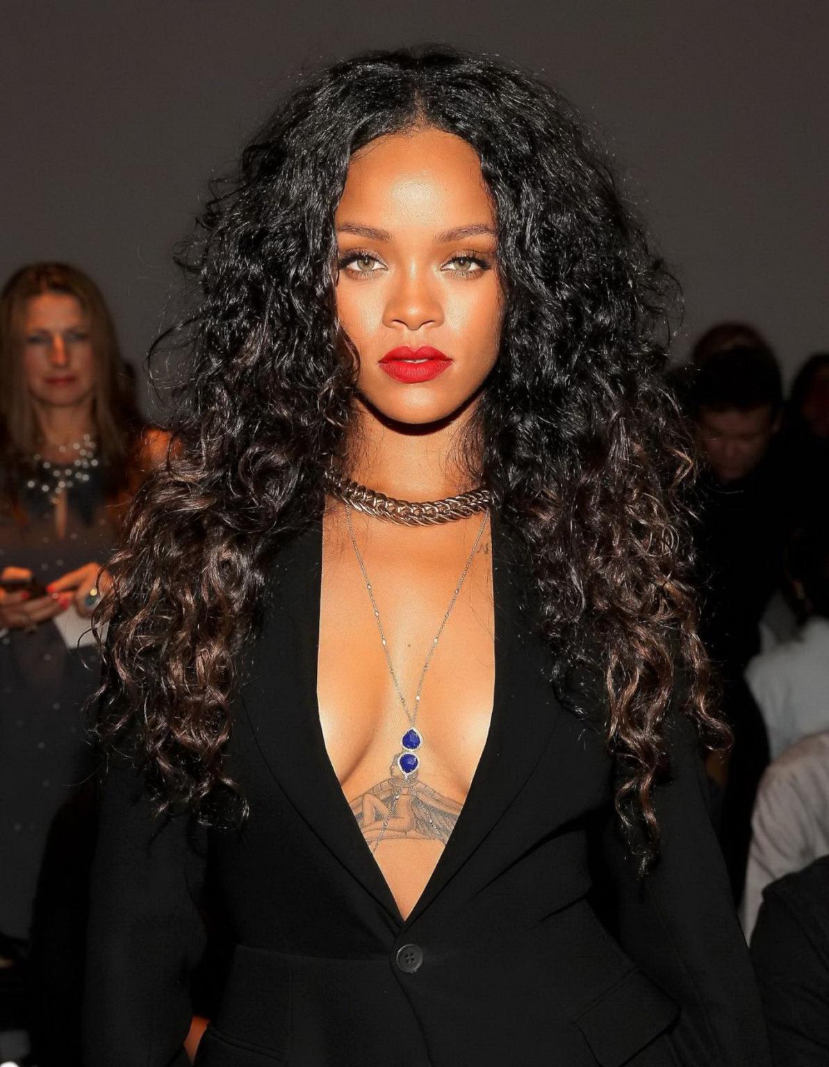 16P Rihanna cleavy and flashing her panties in a wide open black mini dress at the f