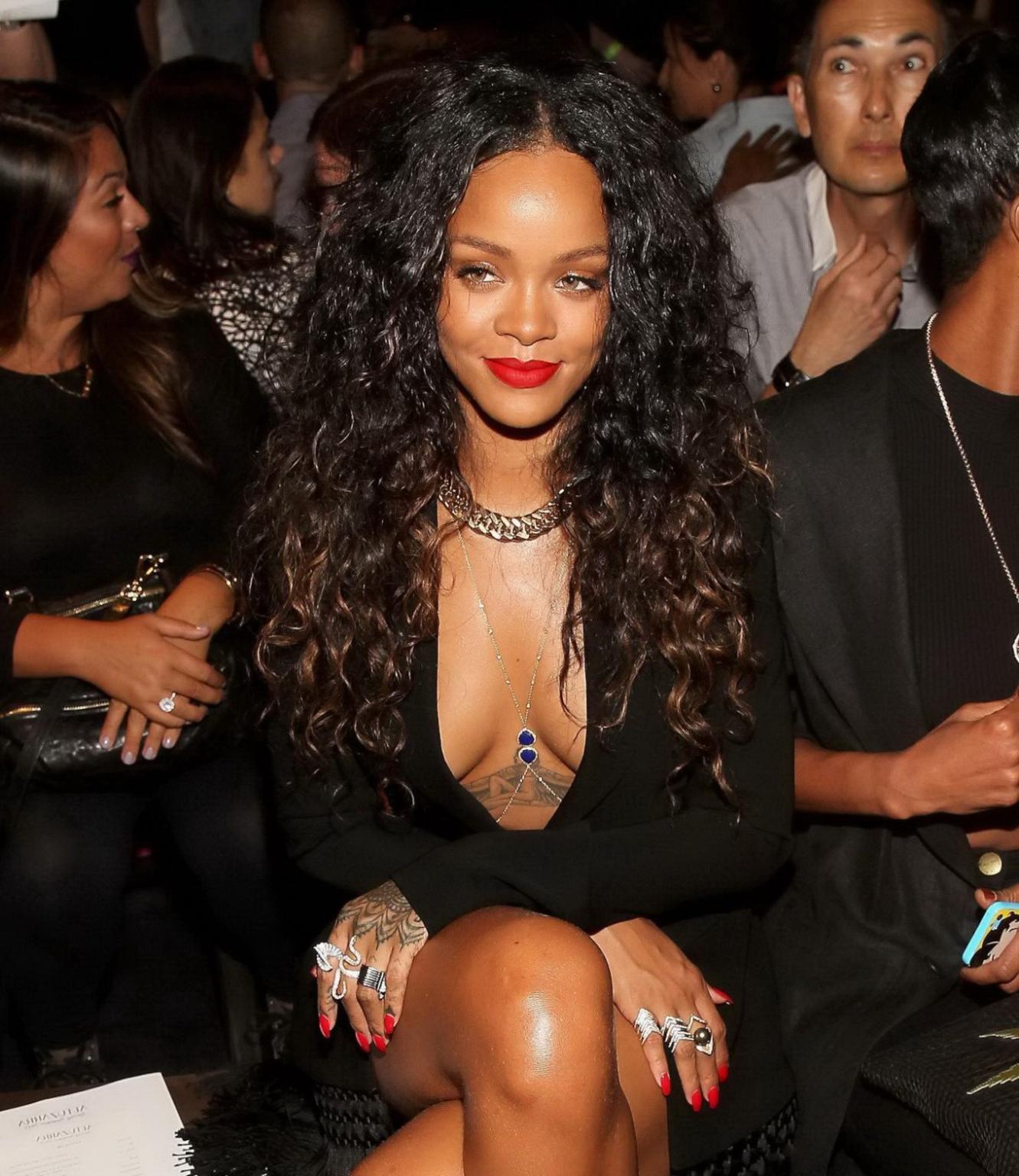 16P Rihanna cleavy and flashing her panties in a wide open black mini dress at the f