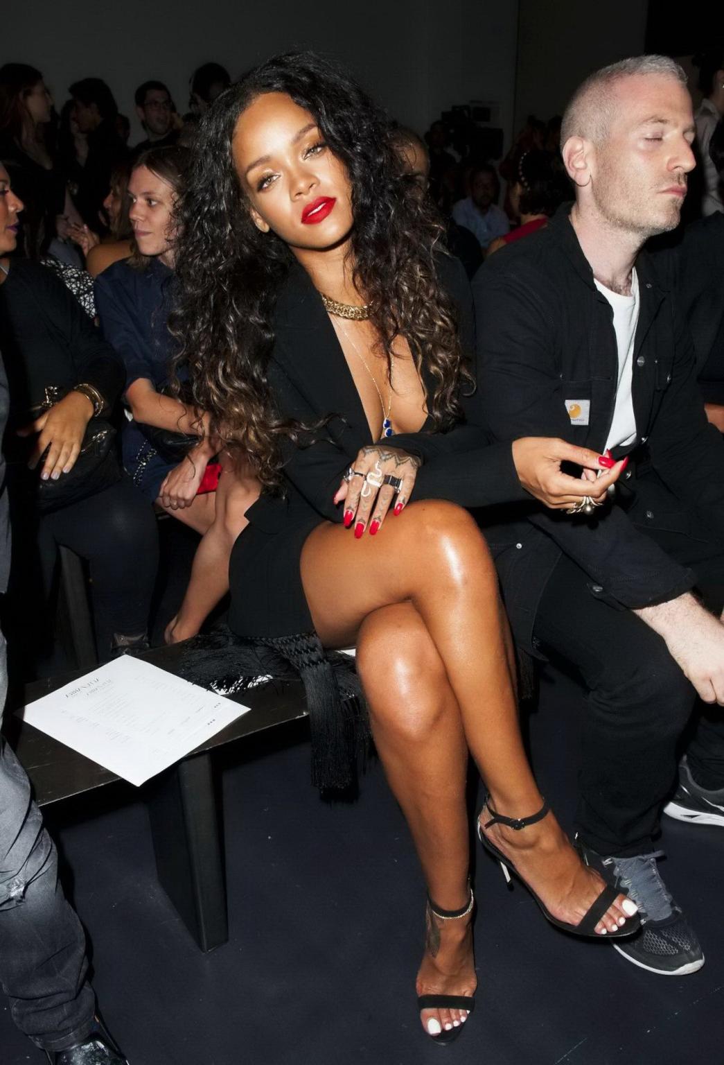 16P Rihanna cleavy and flashing her panties in a wide open black mini dress at the f