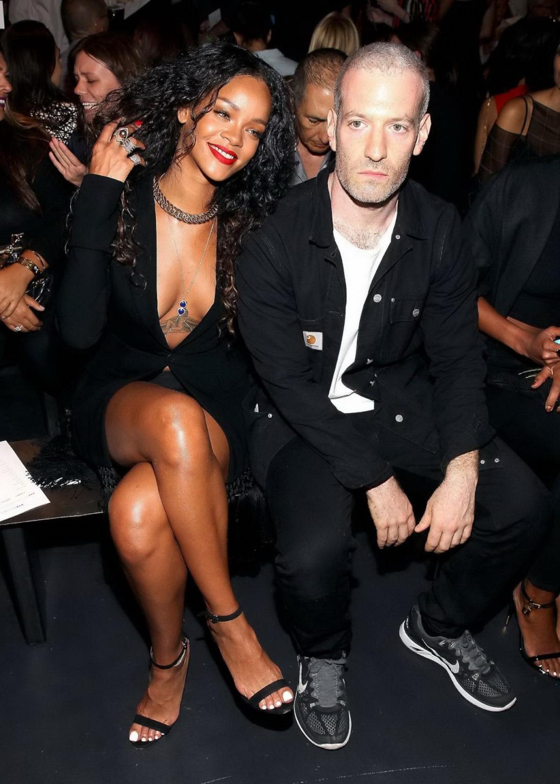 16P Rihanna cleavy and flashing her panties in a wide open black mini dress at the f