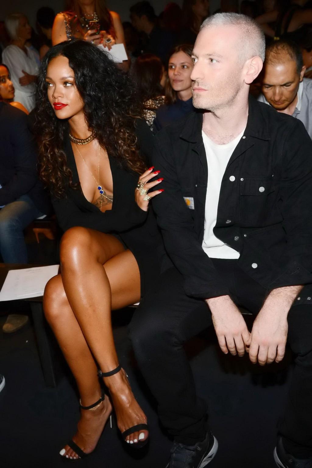 16P Rihanna cleavy and flashing her panties in a wide open black mini dress at the f