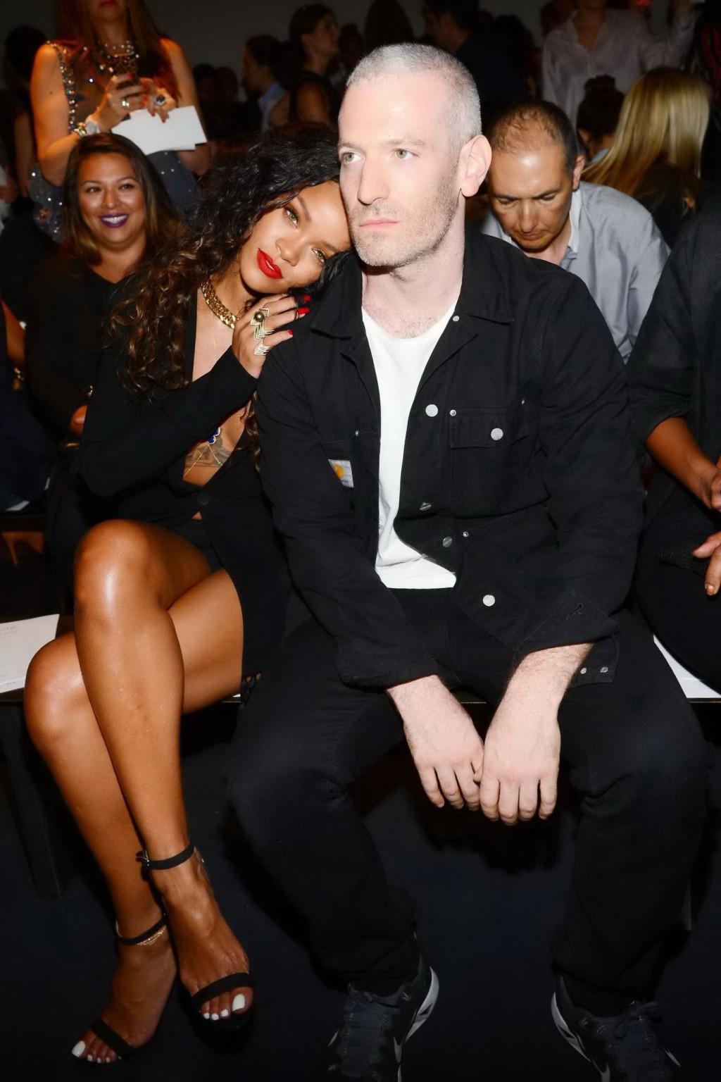 16P Rihanna cleavy and flashing her panties in a wide open black mini dress at the f