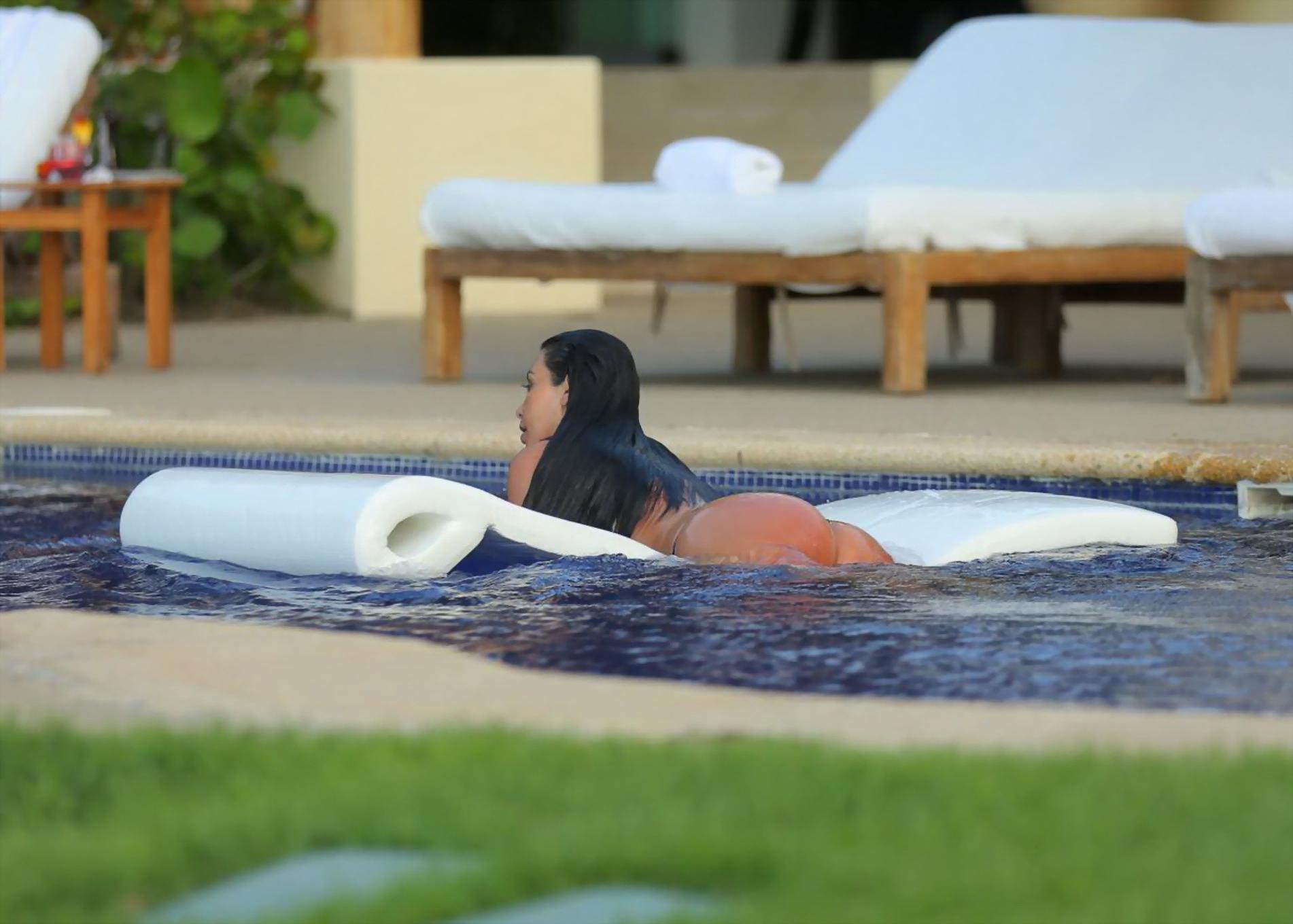 16P Kim Kardashian shows off her huge boobs in a wet seethru top poolside in Mexico