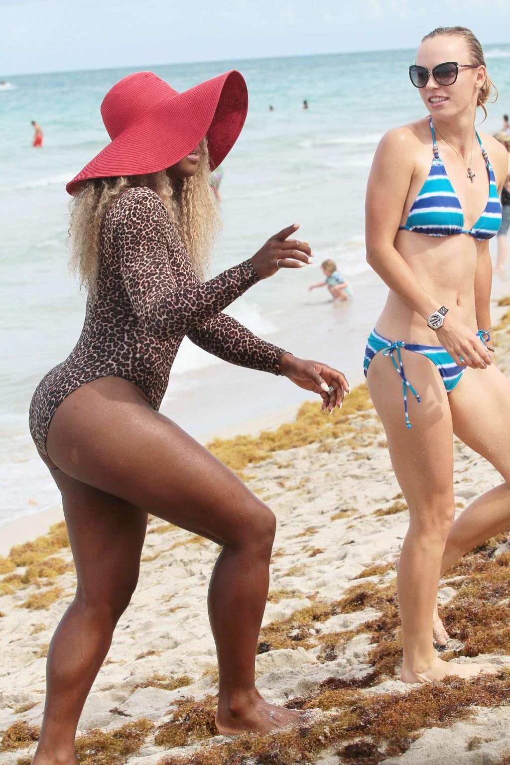 16P Serena Williams shows off her curvy body wearing a leopard print swimsuit on a b