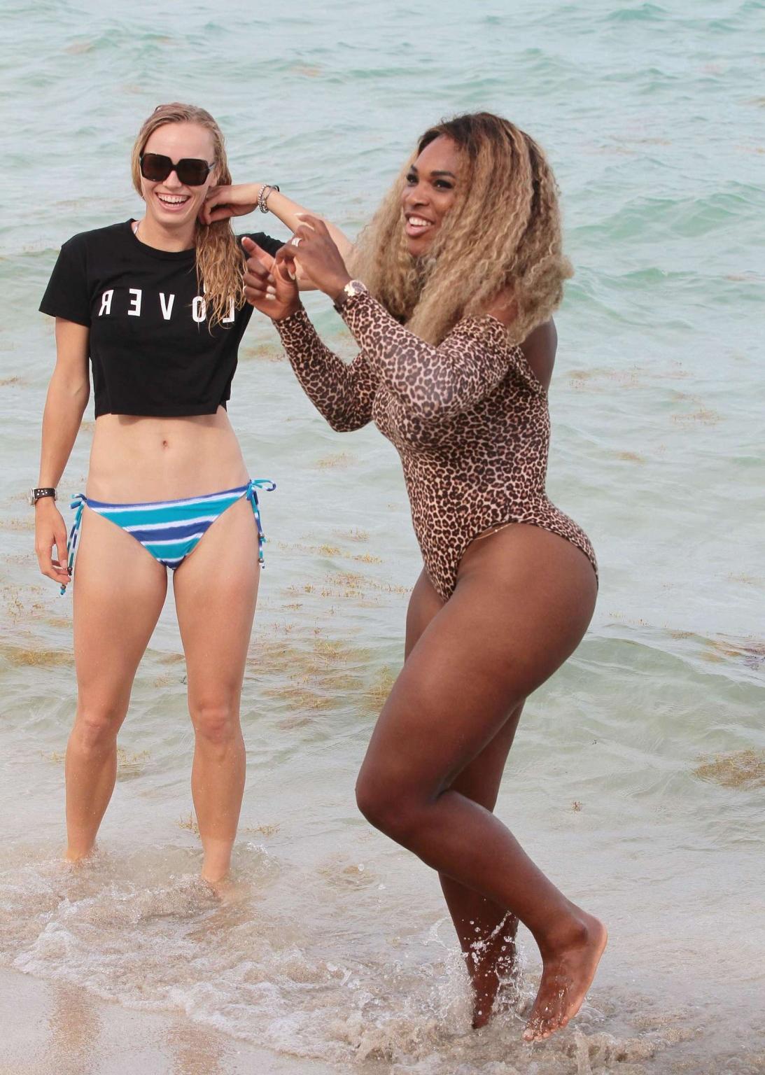 16P Serena Williams shows off her curvy body wearing a leopard print swimsuit on a b
