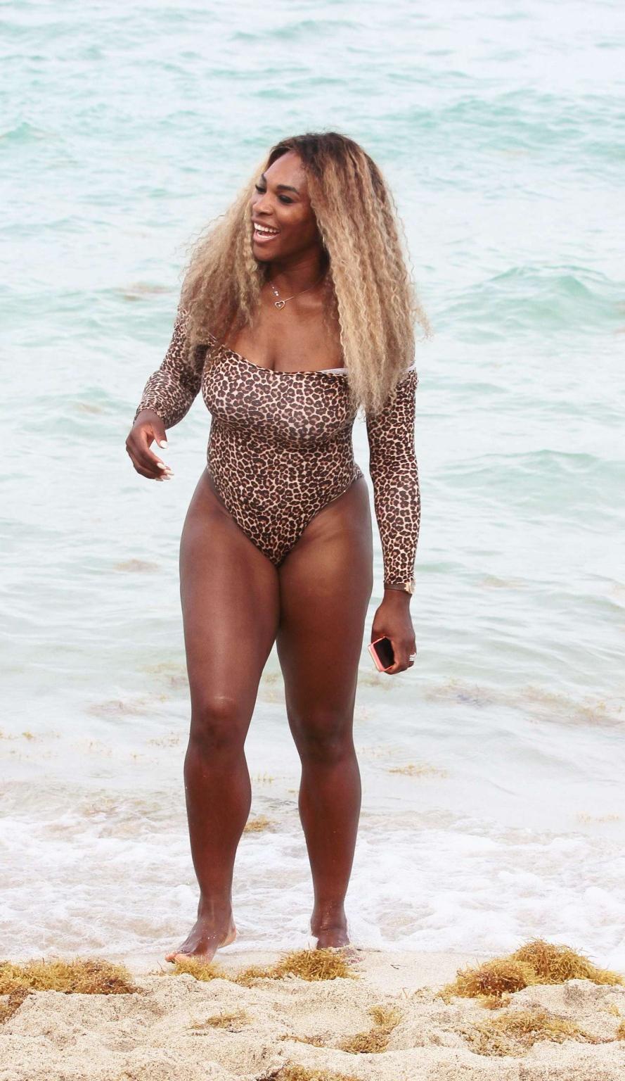 16P Serena Williams shows off her curvy body wearing a leopard print swimsuit on a b